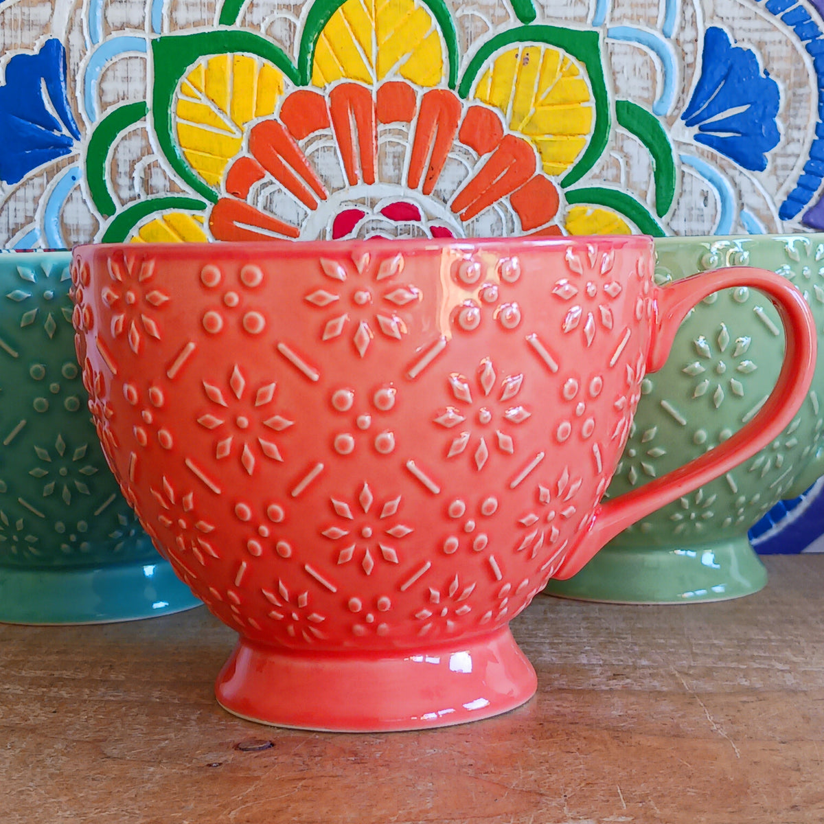 Bring the warmth and colour of the Mediterranean into your home with this beautiful Tuscany-inspired ceramic mug. Featuring a vibrant glazed exterior and an eye-catching embossed geometric pattern inside, this stylish mug is inspired by the rustic terracotta tiles and intricate murals found in sun-soaked Italian villages.