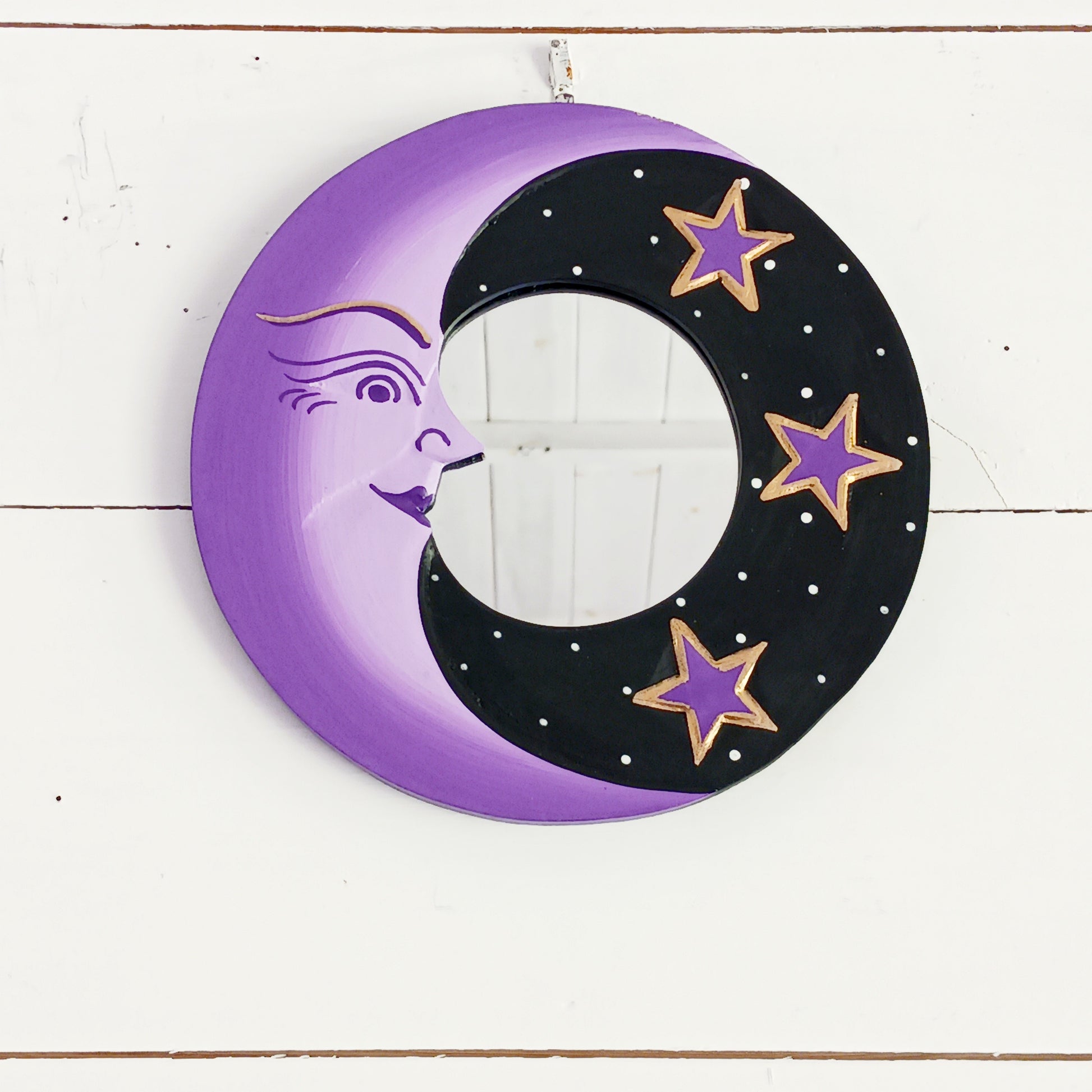 Bring celestial charm and positive energy into your home with this little Handmade Purple Moon Mirror. Carefully crafted by Fair Trade artisans, this unique decorative mirror features a stunning purple crescent moon design that adds a mystical and spiritual touch to any room.
