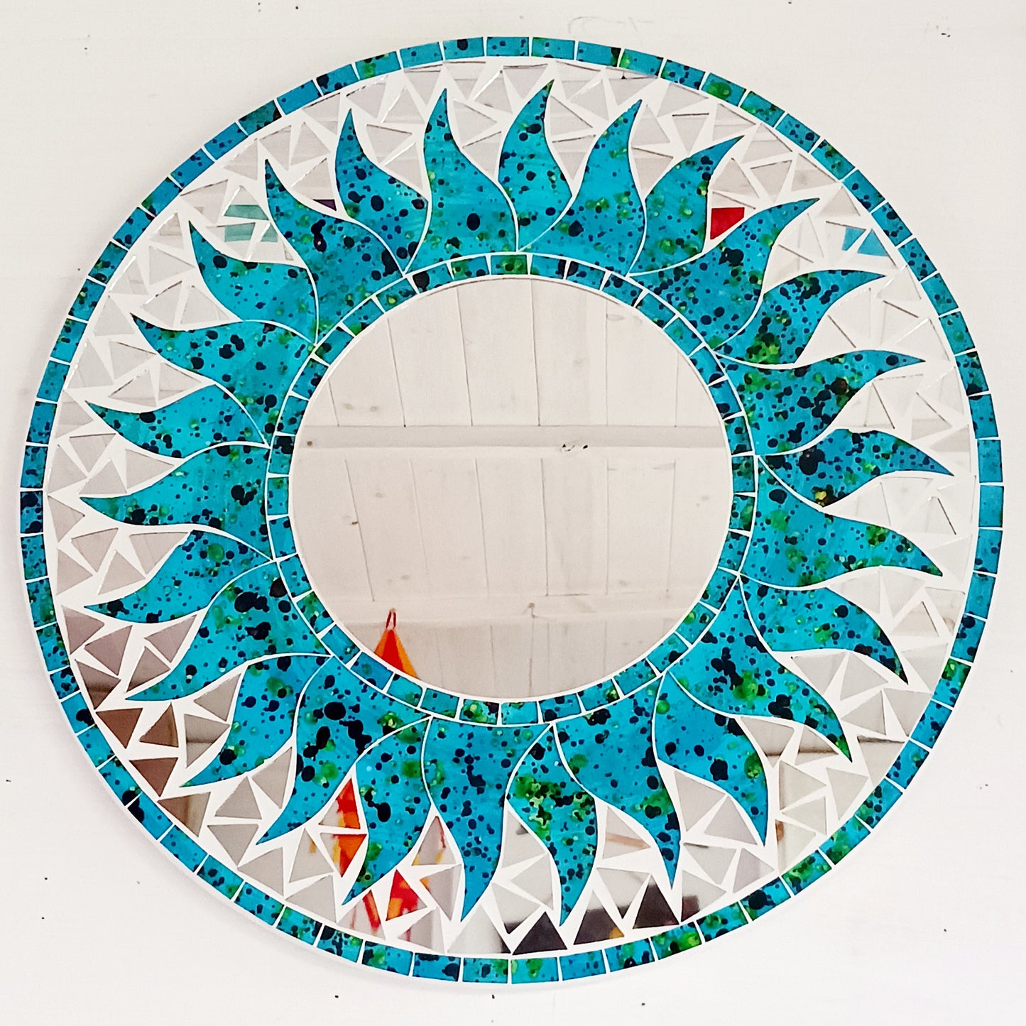 Add warmth, energy, and artistic charm to your home with this beautiful Vibrant Turquoise Mosaic Sun Mirror. Designed with dazzling turquoise mosaic tiles arranged in a radiant sunburst pattern, this captivating wall accent instantly brightens any room. 