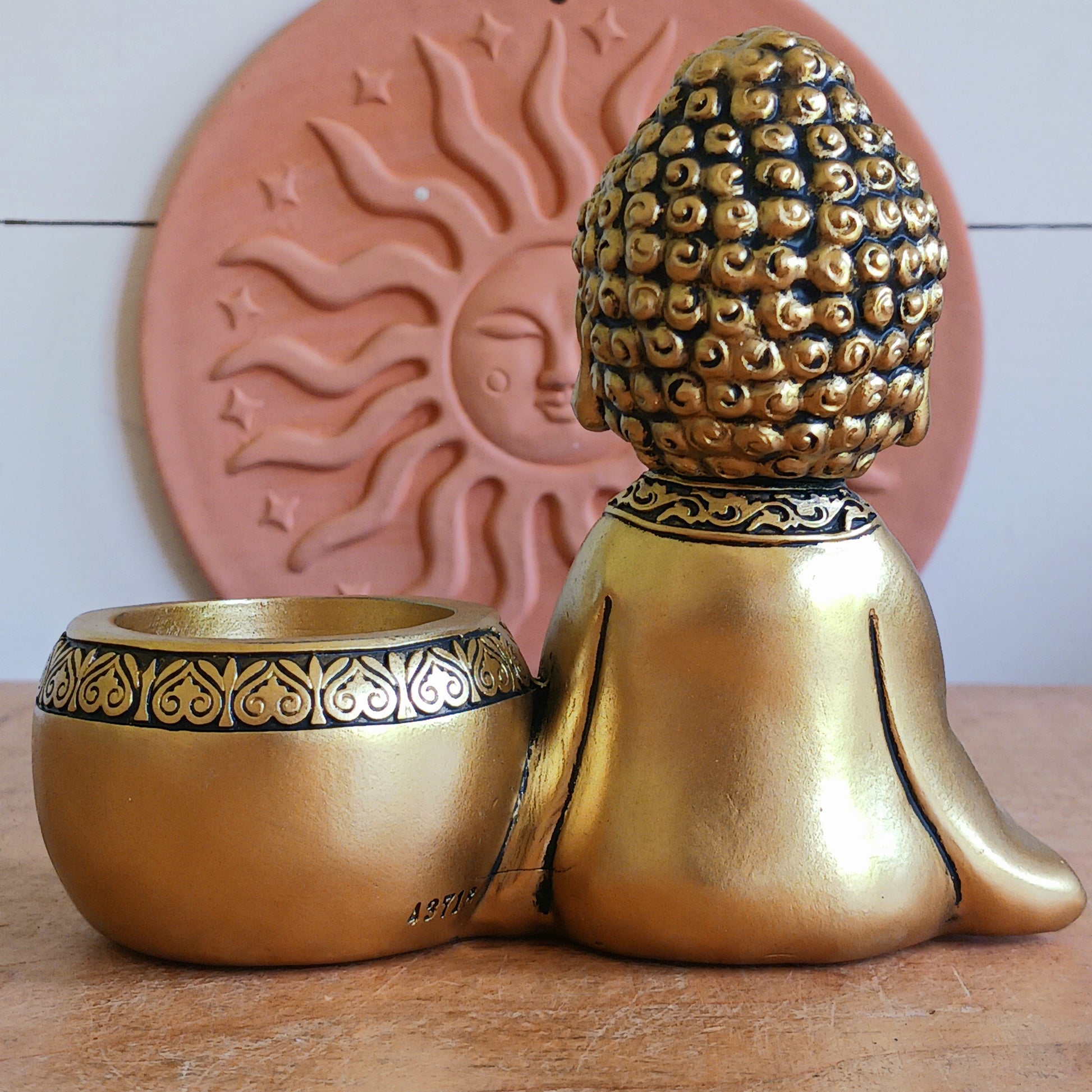 Bring a sense of peace and mindfulness into your home with this elegant Gold Buddha Tealight Candle Holder. Featuring a beautifully crafted praying Buddha figure alongside a tealight holder, this decorative piece creates a calming ambiance wherever it is placed.