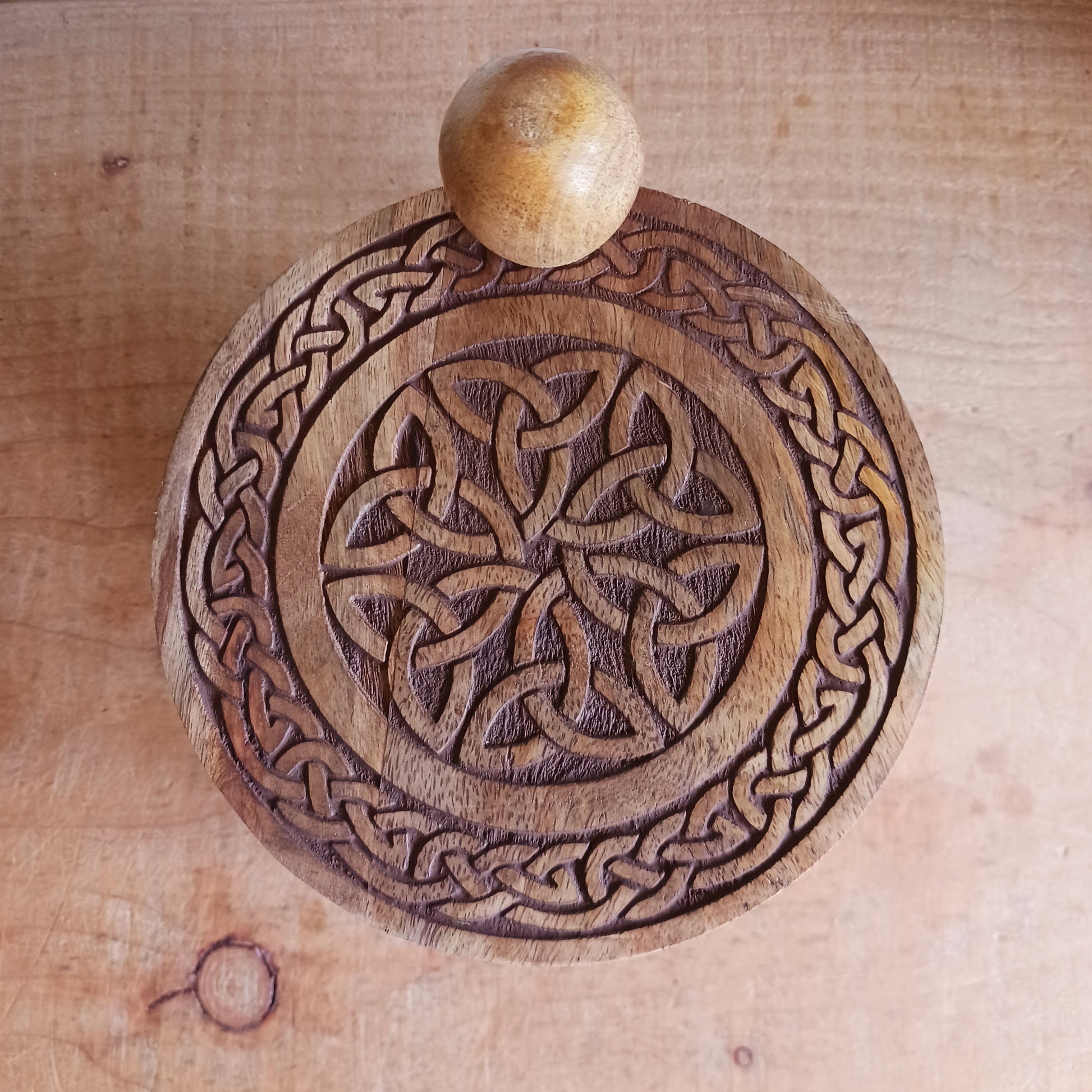 Bring timeless craftsmanship and functional beauty into your space with this Celtic Carved Revolving Storage Box, expertly hand-crafted from sustainable mango wood. Designed with both elegance and practicality in mind, this unique 3-tier swivel box opens smoothly from a central pivot, revealing three spacious compartments that fan out effortlessly.