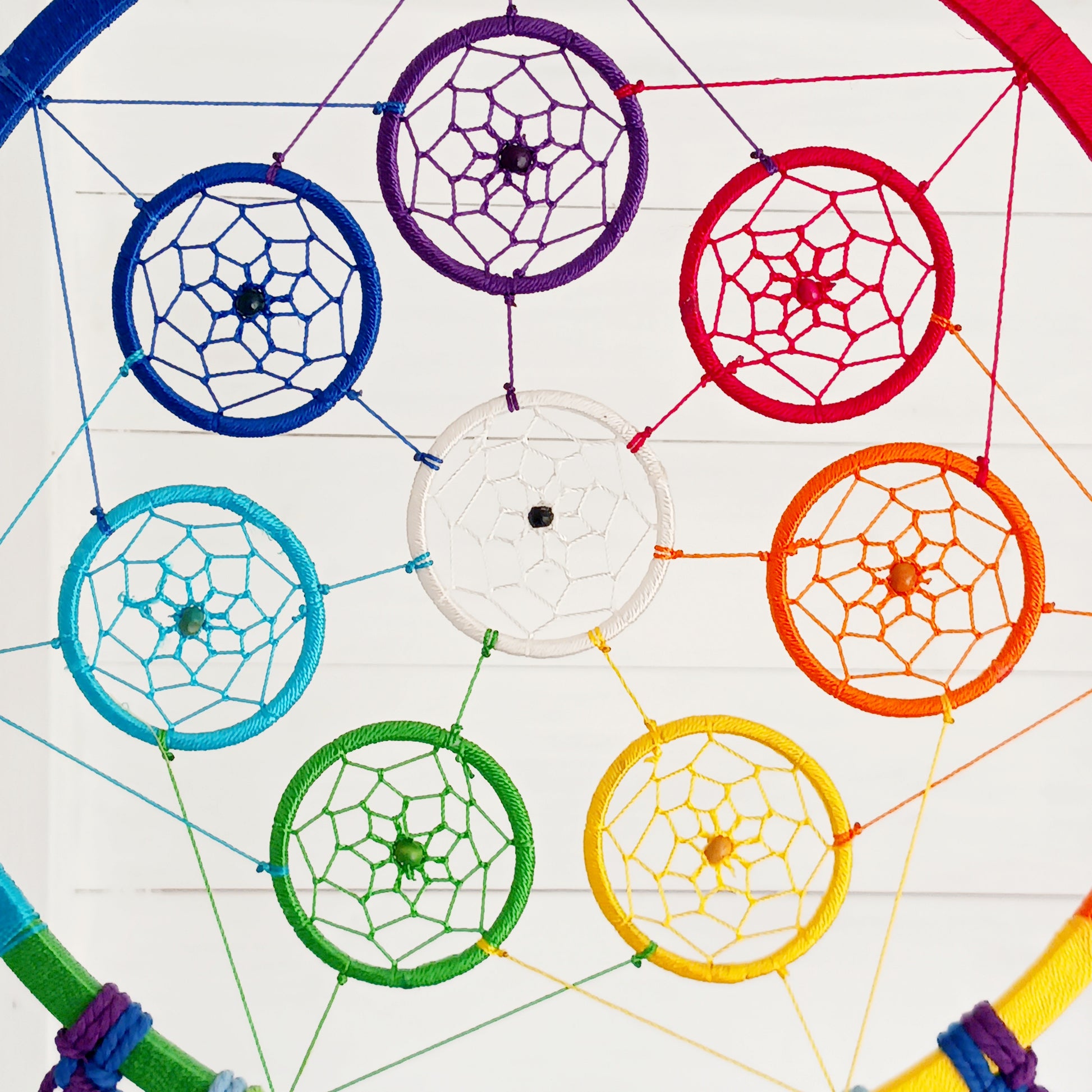 Bring harmony, colour, and positive energy into your space with this large, vibrant dreamcatcher. Featuring seven small hoops representing each of the chakras, this stunning piece is hand-crafted with bright rainbow crocheting. Ideal as a wall hanging, it makes a thoughtful gift for yoga lovers, meditation enthusiasts, or anyone seeking balance and wellbeing. Perfect for adding a spiritual touch to your home décor while promoting peace and positivity.
