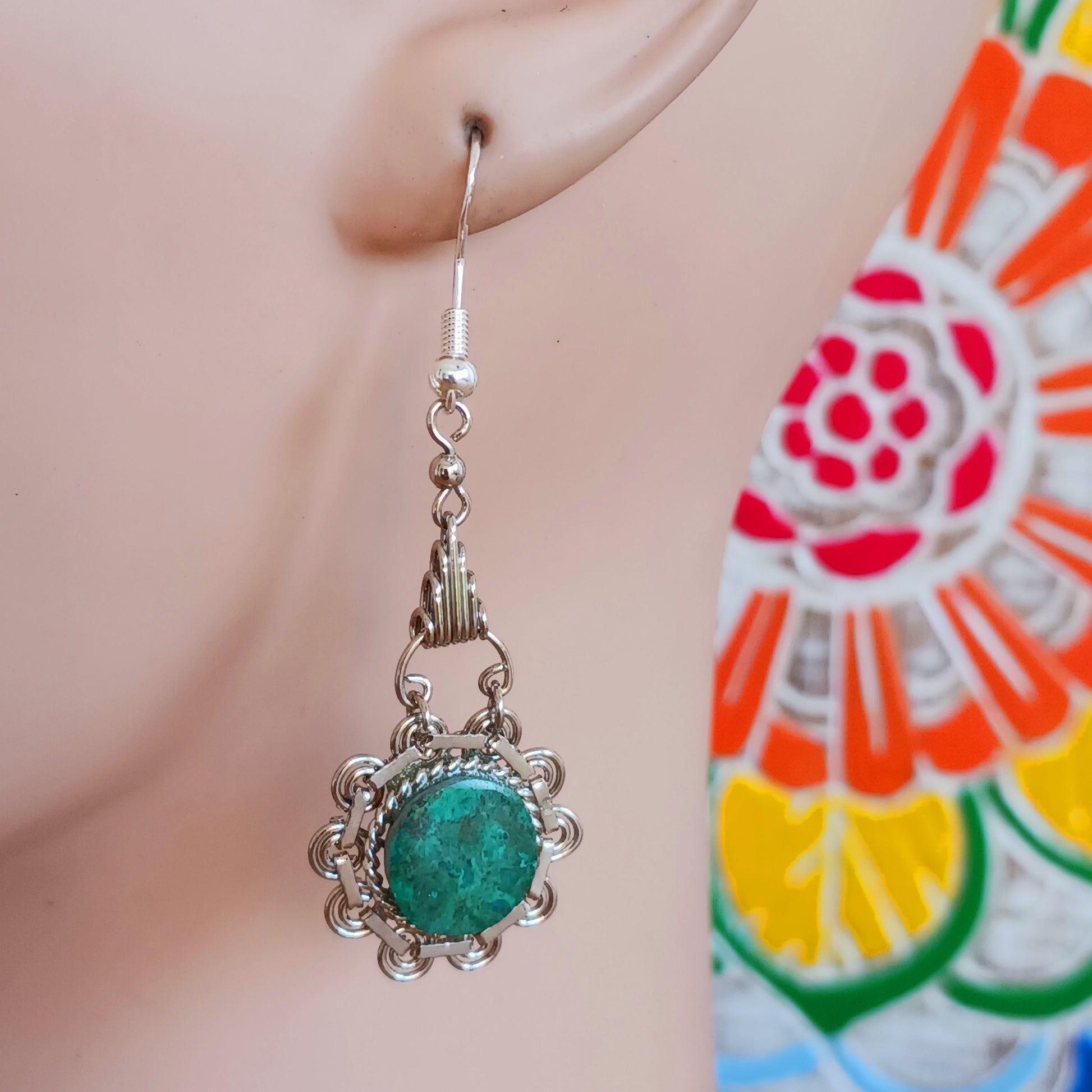 Add a touch of bohemian beauty to your look with these handmade Peruvian stone earrings. Featuring green turquoise stones and finished with silver-plated hooks, each pair is carefully crafted in small workshops in Peru.