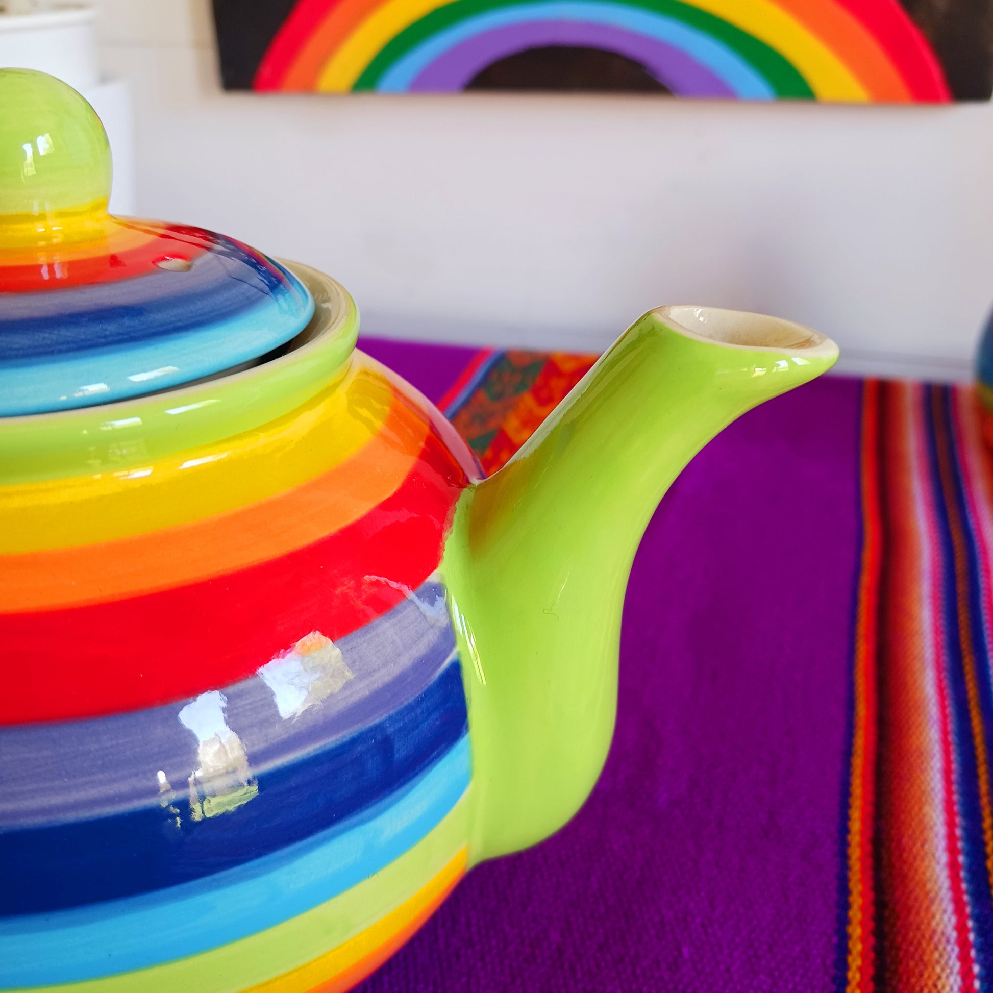 Experience the perfect fusion of artistry and functionality with this exquisite 2-cup ceramic teapot from Thailand. Handcrafted by skilled artisans, this vibrant teapot features a stunning rainbow stripe, adding a pop of colour and charm to your tea rituals.