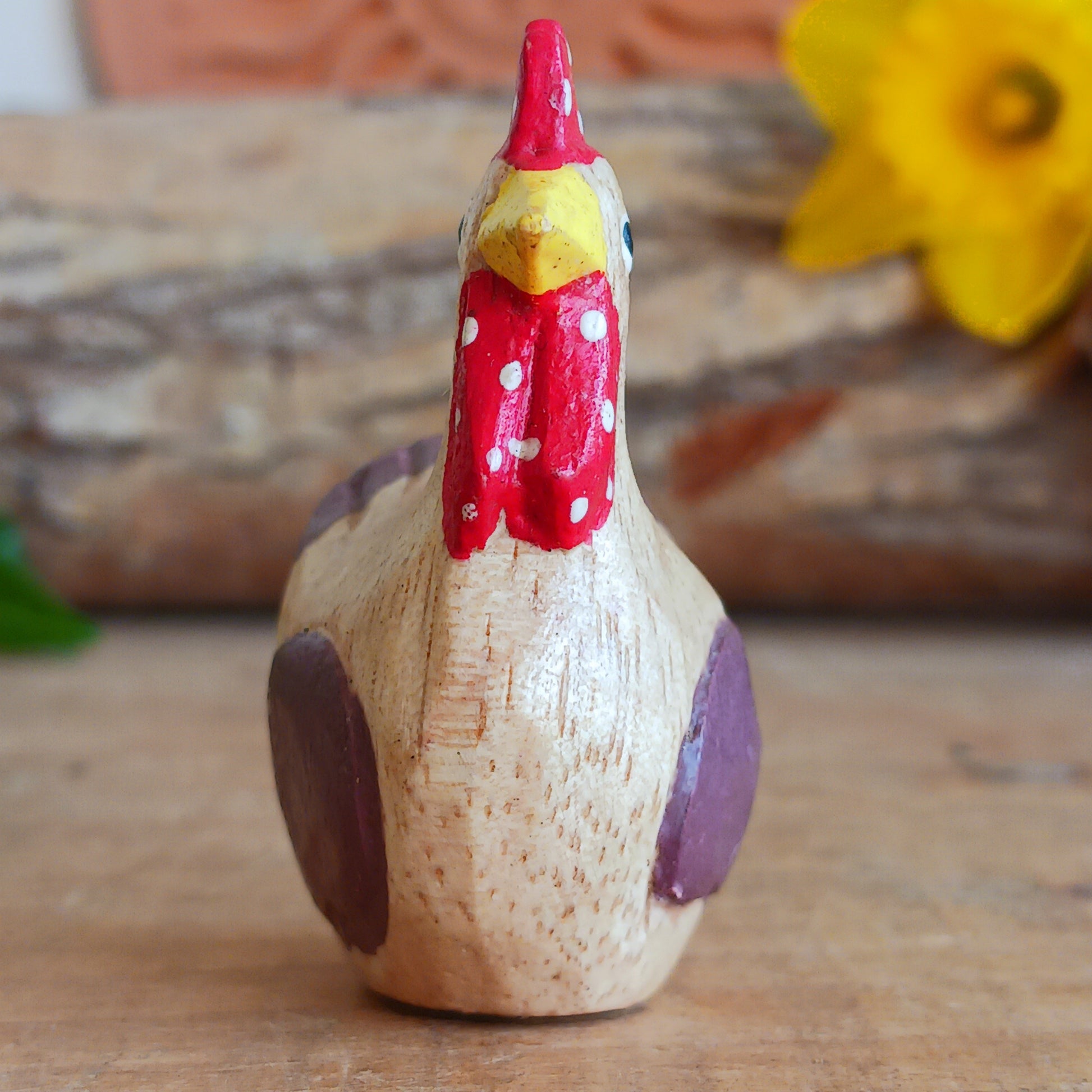 Add a touch of countryside charm to your home with this rustic mini wooden chicken ornament. Hand carved from sustainable Jempinis wood by skilled artisans in Indonesia, each piece is carefully painted in a rustic farmyard style that highlights the natural character of the wood.