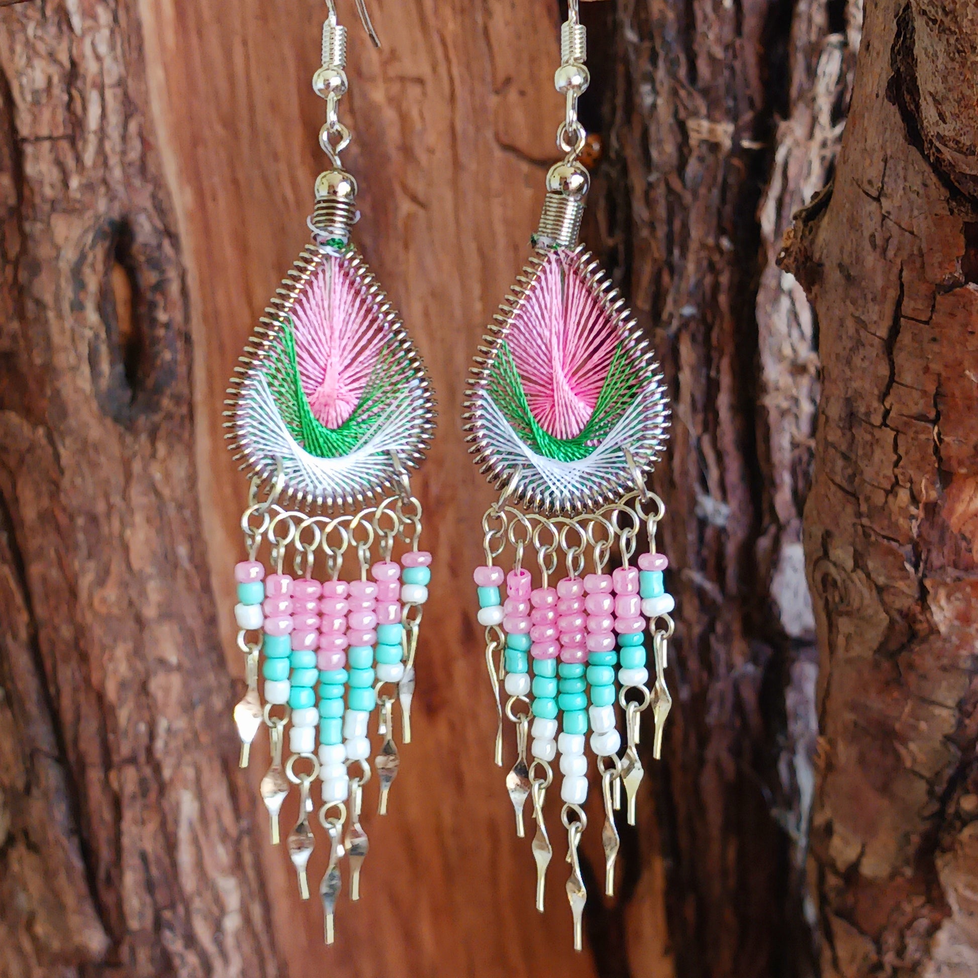 These beautiful and eye-catching earrings are handmade in Peru and feature an array of gorgeous colours. A woven teardrop, similar in style to a peacock feather, is finished with co-ordinating beads and silver embellishments. Ideal for a night out or for dressing up your boho look!