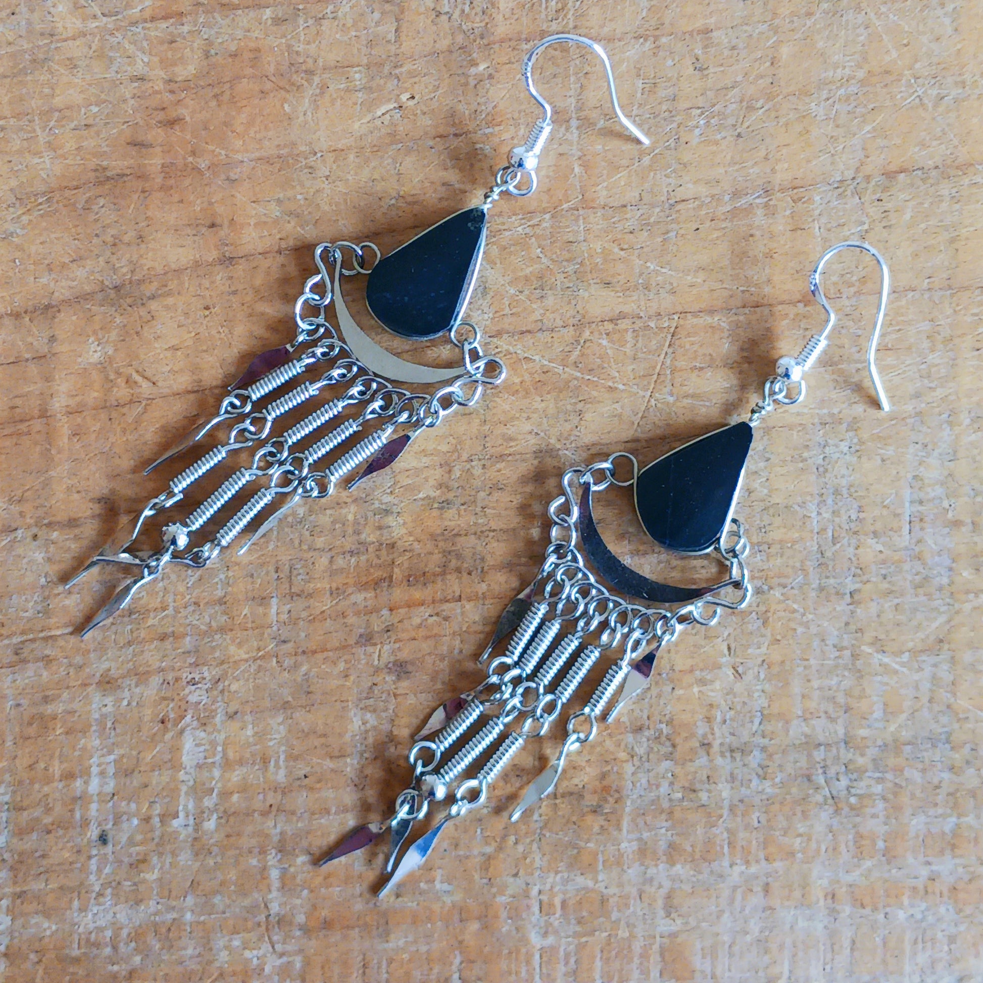 Add a touch of bohemian beauty to your look with these handmade Peruvian stone earrings. Featuring black stones and finished with silver-plated hooks, each pair is carefully crafted in small workshops in Peru.