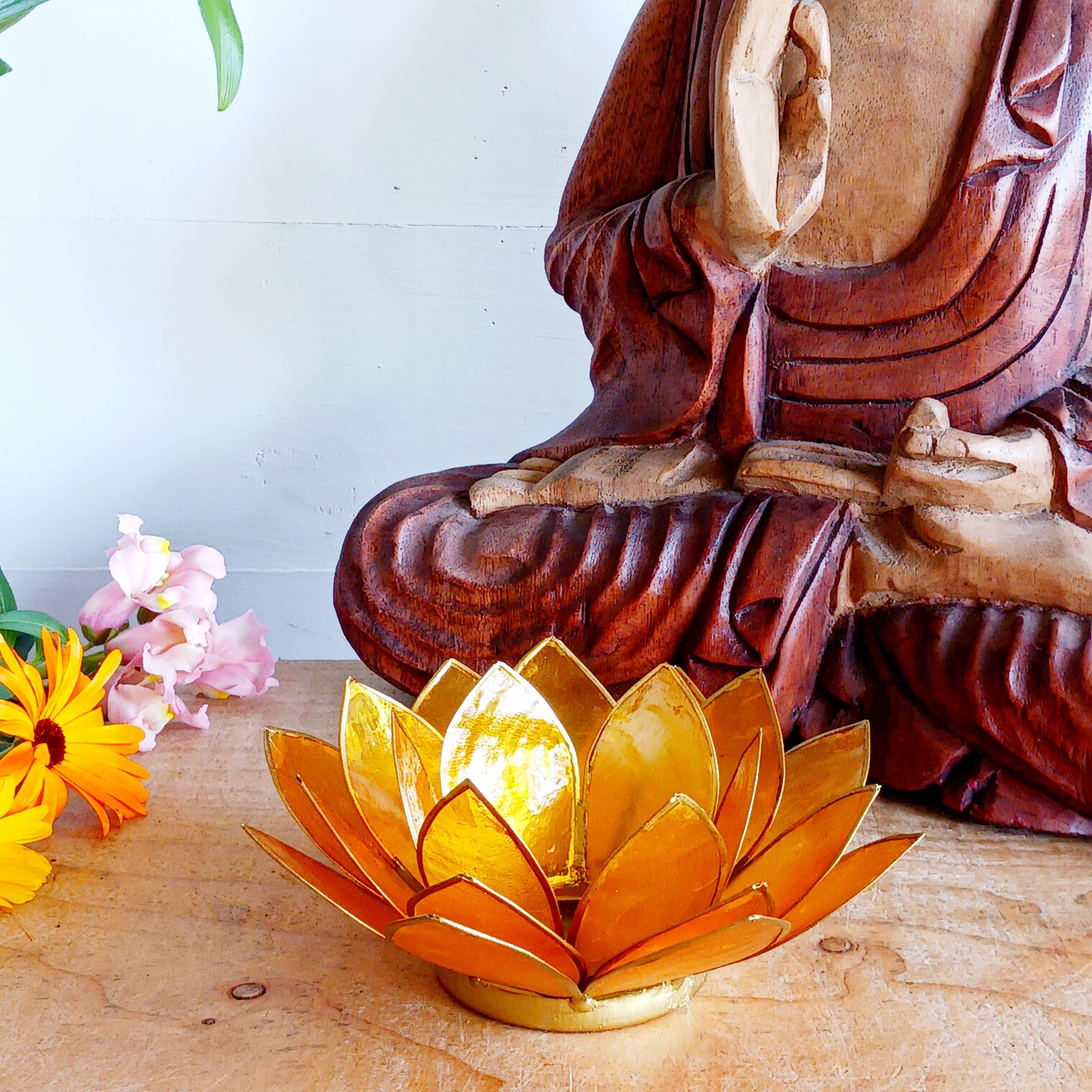 Illuminate your space with the peaceful elegance of our Capiz Shell Lotus Flower Candle Holder. Symbolizing enlightenment and serenity, this stunning handcrafted piece features delicate yellow petals edged in gold, forming the iconic lotus shape.