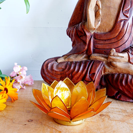 Illuminate your space with the peaceful elegance of our Capiz Shell Lotus Flower Candle Holder. Symbolizing enlightenment and serenity, this stunning handcrafted piece features delicate yellow petals edged in gold, forming the iconic lotus shape.