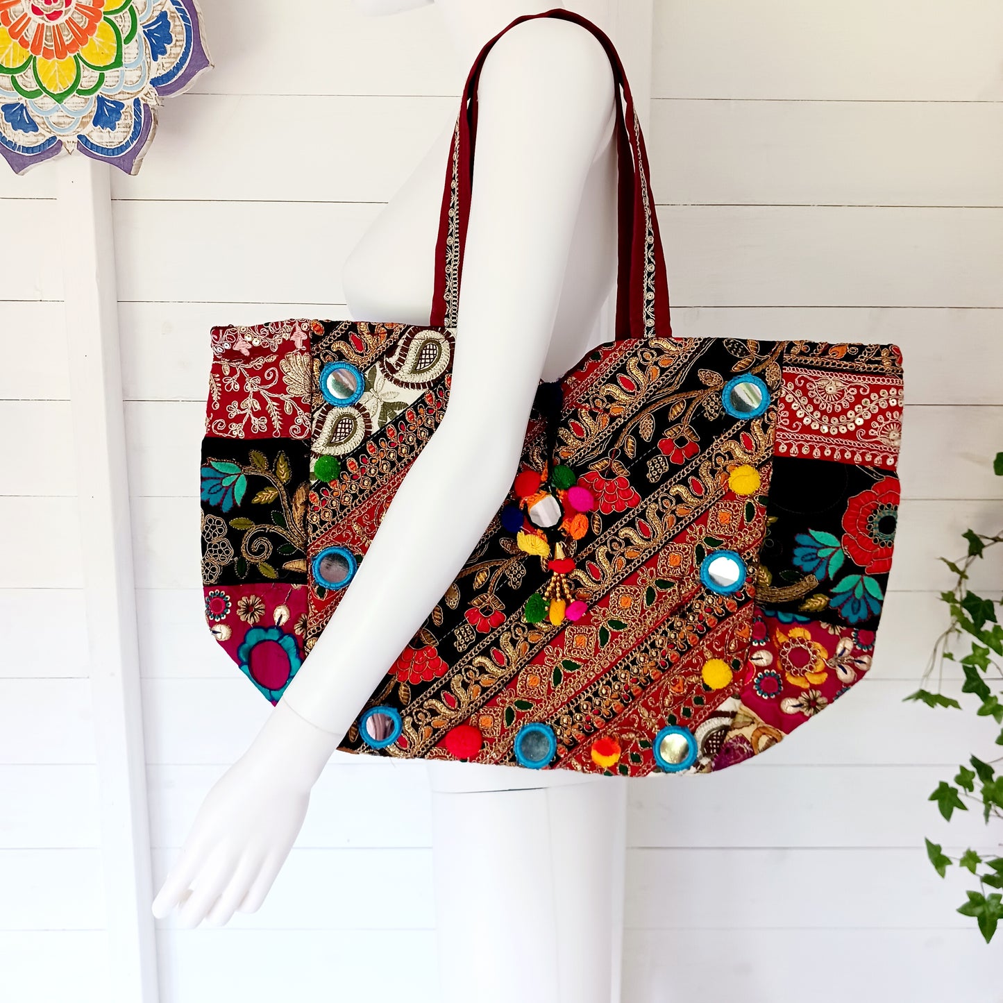 This beautiful large Indian bag comes with a wide shoulder strap and plenty of space inside for your personal items. In a patchwork style design, this bag is intricately embroidered with a traditional bohemian pattern. The bag is fully lined throughout.