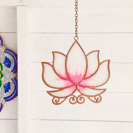 Bring a touch of tranquility to your space with this beautifully crafted lotus flower window hanger. Made from vibrant coloured glass and outlined in sleek metal framing, this piece combines simplicity and elegance. When sunlight passes through, it creates a radiant, uplifting display of color. Hang it in any window to inspire peace, mindfulness, and beauty in your home or workspace.