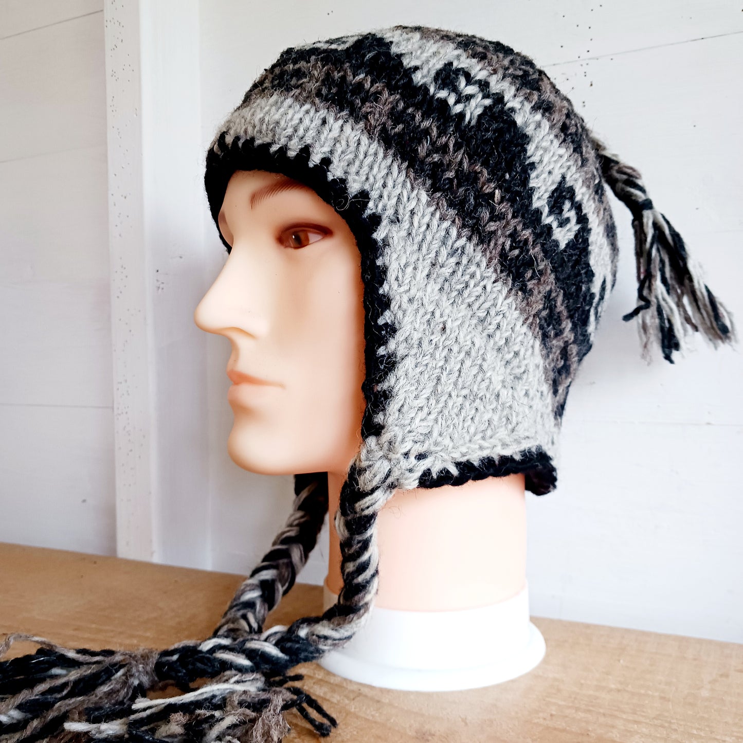Stay cozy and stylish with our handmade chunky wool earflap hats, crafted in Nepal by skilled women artisans in Kathmandu. Each hat is 100% pure wool and features a soft polar fleece lining for extra warmth and comfort. Perfect for cold winter days, outdoor adventures, or adding a touch of handmade charm to your look.