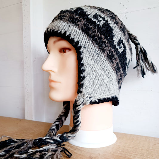 Stay cozy and stylish with our handmade chunky wool earflap hats, crafted in Nepal by skilled women artisans in Kathmandu. Each hat is 100% pure wool and features a soft polar fleece lining for extra warmth and comfort. Perfect for cold winter days, outdoor adventures, or adding a touch of handmade charm to your look.