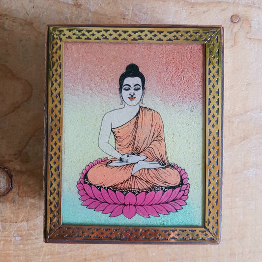 Bring peace and elegance to your space with this exquisite decorative mango wood box. Featuring a vibrant sand painting of Buddha in the meditation mudra, this piece is a true work of art. The detailed image is first hand-painted on a glass top and then filled with colourful sand, giving it depth and texture.