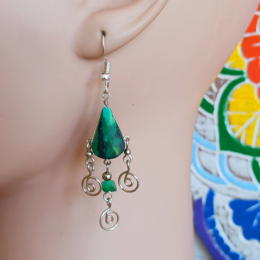 These beautiful spiral earrings feature a turquoise stone and three spirals. They dangle really nicely when worn, and are easy to dress up or down. The hooks are made from sterling silver.