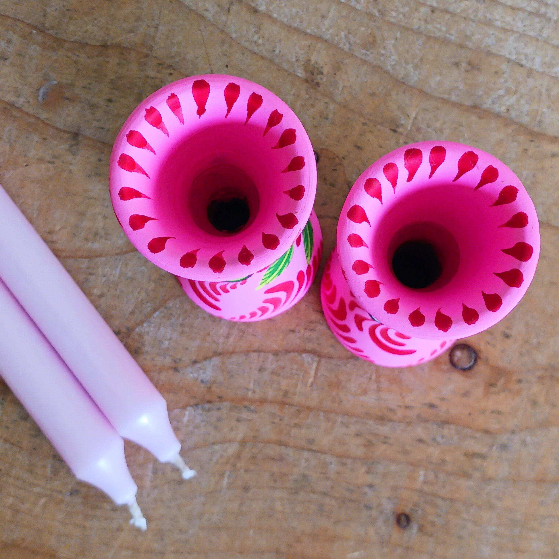 Hand painted in a vibrant&nbsp;pink&nbsp;hue and adorned with the Shapla (waterlily) flower — the national flower of Bangladesh, this fair trade candle holder is a true statement piece. Display it prominently or gift it to someone special as a unique, ethical, and meaningful present. Beautiful on its own or paired with others, it adds warmth, tradition, and cheerful design to any space.