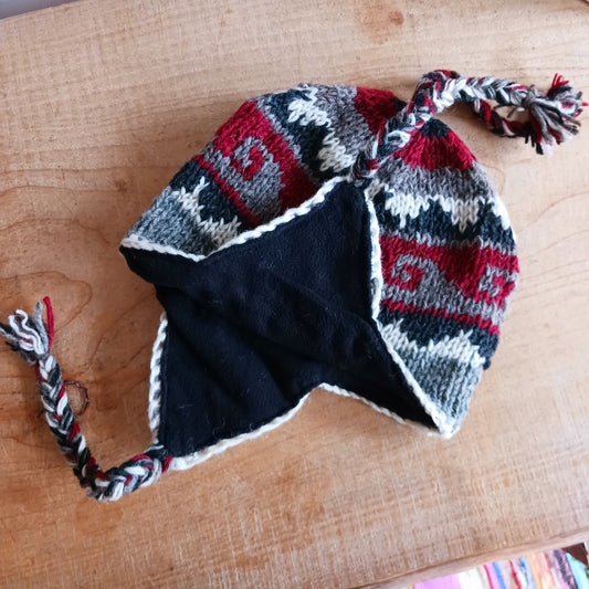 Stay cozy and stylish with our handmade chunky wool earflap hats, crafted in Nepal by skilled women artisans in Kathmandu. Each hat is 100% pure wool and features a soft polar fleece lining for extra warmth and comfort. Perfect for cold winter days, outdoor adventures, or adding a touch of handmade charm to your look.