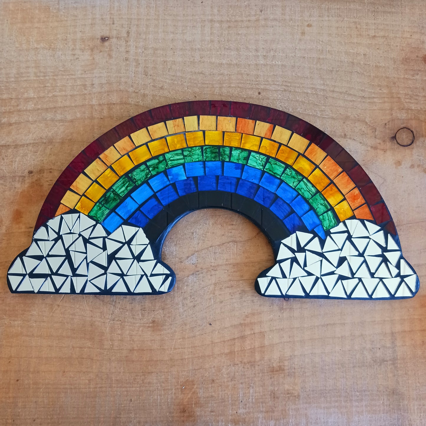 Bring colour, light, and personality into your home with the Mosaic Rainbow Wall Mirror Plaque. Featuring a vibrant rainbow-inspired mosaic design with a reflective mirror centre, this decorative wall plaque adds a cheerful touch to bedrooms, nurseries, playrooms, living spaces, or hallways.