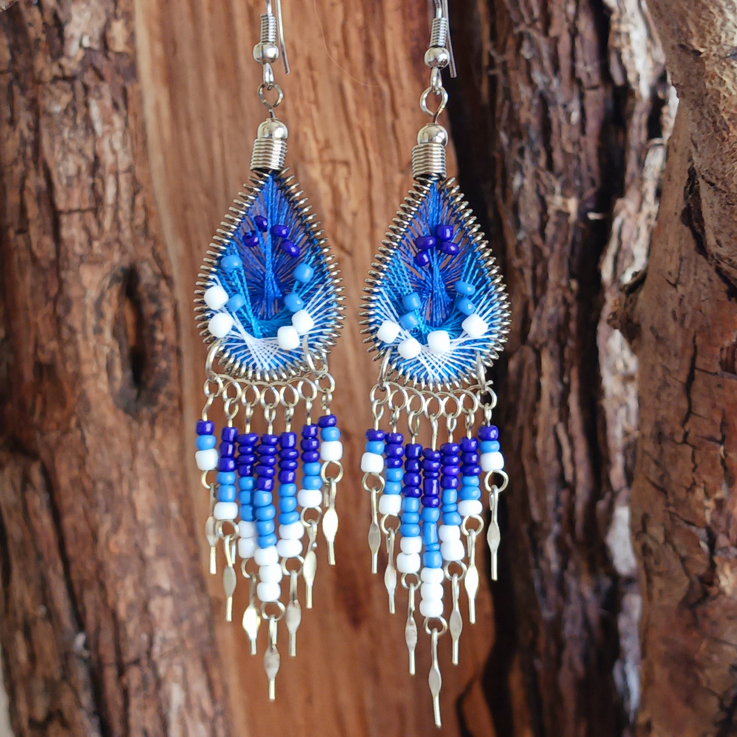 Add a splash of colour to your look with these beautiful handmade Peruvian woven teardrop earrings. Inspired by the vibrant colours and patterns of a peacock feather, each earring features intricate woven detailing complemented by coordinating beads and delicate silver-tone embellishments.