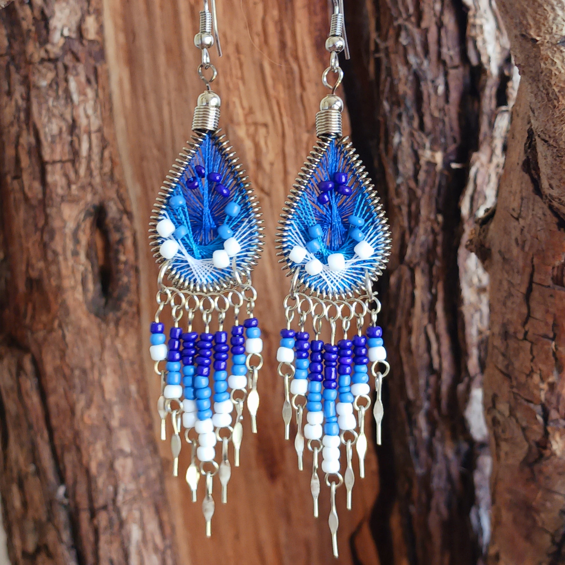 Add a splash of colour to your look with these beautiful handmade Peruvian woven teardrop earrings. Inspired by the vibrant colours and patterns of a peacock feather, each earring features intricate woven detailing complemented by coordinating beads and delicate silver-tone embellishments.