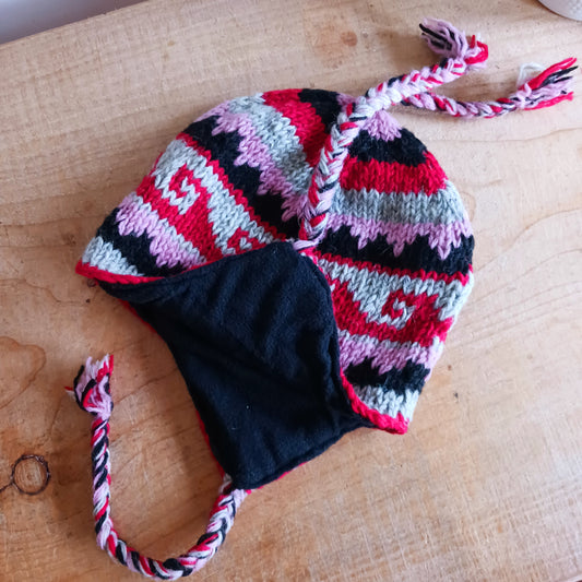 Stay cozy and stylish with our handmade chunky wool earflap hats, crafted in Nepal by skilled women artisans in Kathmandu. Each hat is 100% pure wool and features a soft polar fleece lining for extra warmth and comfort. Perfect for cold winter days, outdoor adventures, or adding a touch of handmade charm to your look.