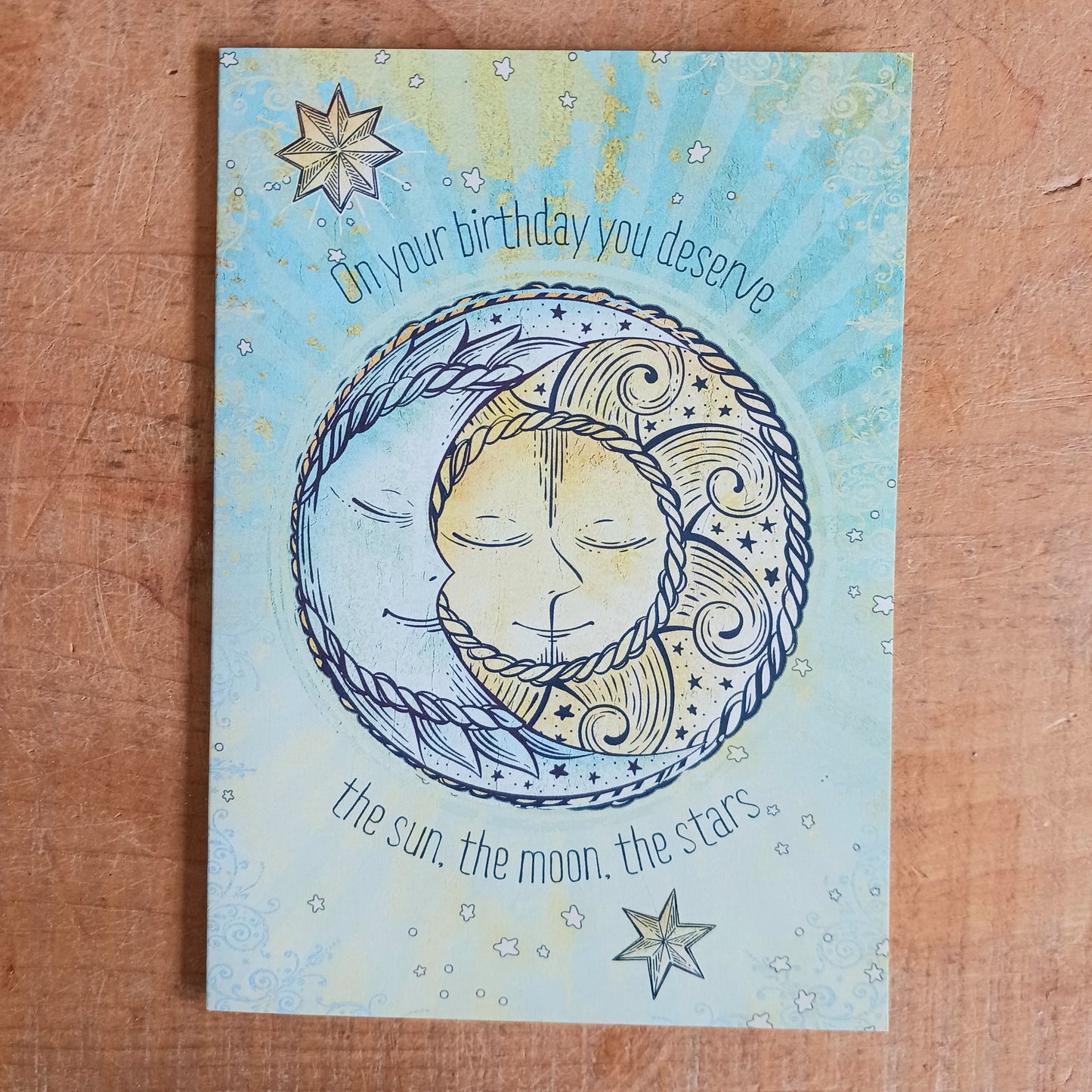 Sun, Moon and Stars greetings card for birthday. Inside the message reads: .....and so much more! Happy Birthday. The card comes with an illustrated envelope. Each card also has faint artwork inside.