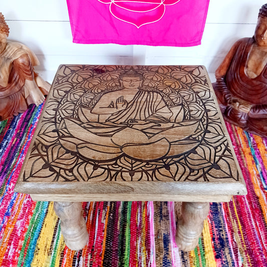 Bring peace and tranquillity to your home with this beautiful handcrafted mango wood table, featuring an intricately carved Buddha and Lotus Flower design on the tabletop. Combining traditional craftsmanship with spiritual symbolism, this unique wooden table makes a wonderful addition to a meditation space, Buddhist altar, yoga room or peaceful home sanctuary.