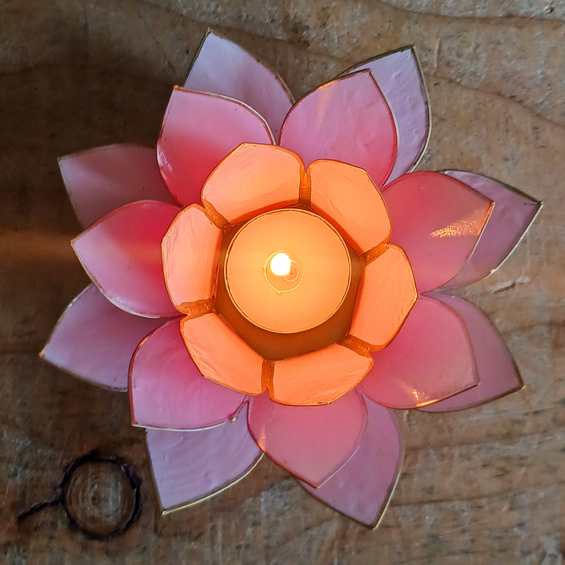 Crafted from natural Capiz shells sustainably harvested from the Philippines, this Fairtrade candle holder accommodates tealight or small candles up to 5.5cm in diameter. The translucent shells bring warmth and beauty to any setting, while celebrating ethical craftsmanship and the artistry of Filipino shell work.
