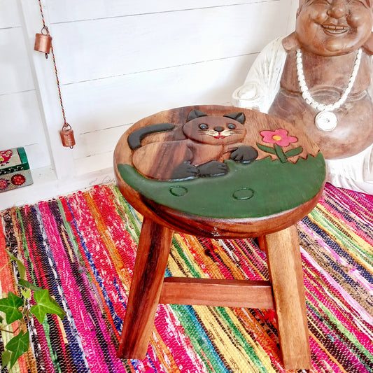 Bring a sprinkle of wonder into your sacred space with this charming hand-painted Cute Cat Stool. Carved from sustainable wood and finished with natural wax, it’s not just adorable—it’s versatile too. Whether you're grounding yourself on it during morning meditation, using it as a fairy table for crystals and incense, or just resting your weary feet, this little cat is pure joy.