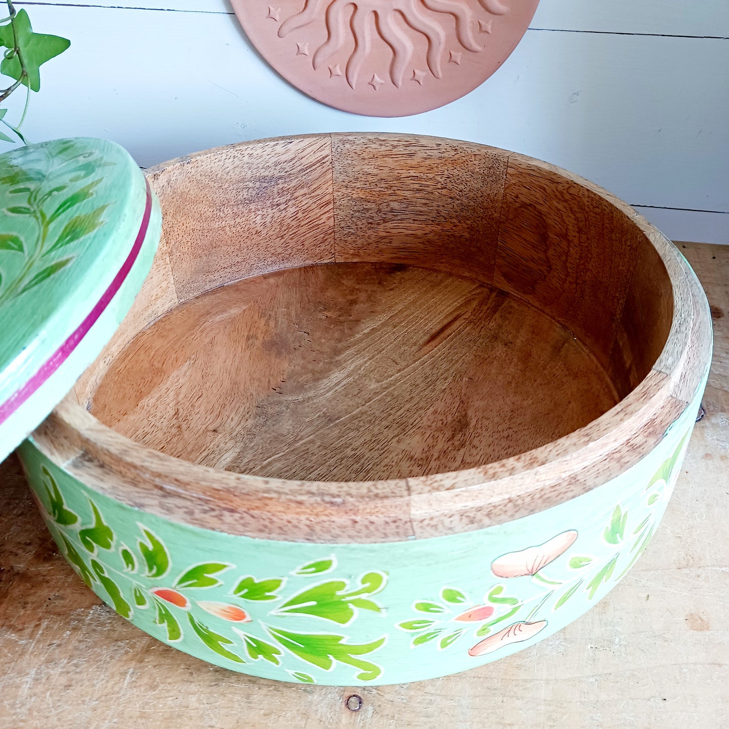 Bring a touch of traditional Indian craftsmanship to your home with this beautiful Handmade Indian Wooden Peacock Decorative Box. Expertly crafted from wood and hand-painted by skilled artisans, this charming round storage box features an elegant peacock design on the pull-off lid, symbolizing beauty, grace, and prosperity.