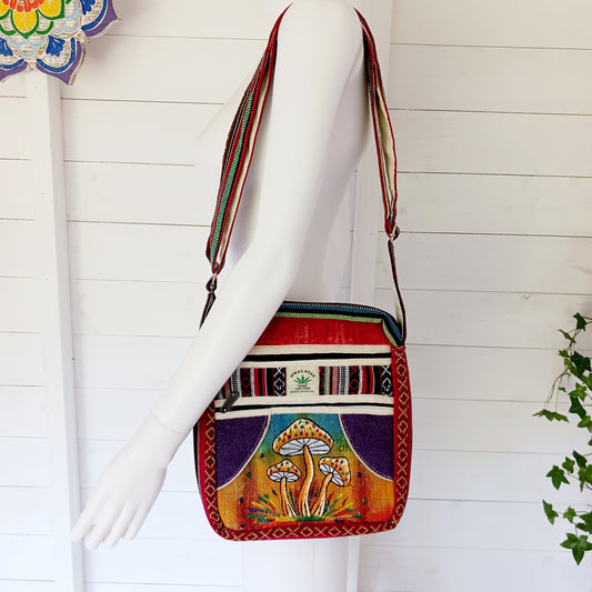This is such a fantastic and handy messenger bag or satchel. Made from hemp with cotton lining, this bag is beautifully crafted featuring lots of handy compartments. On the front are three colourful and embroidered mushrooms.