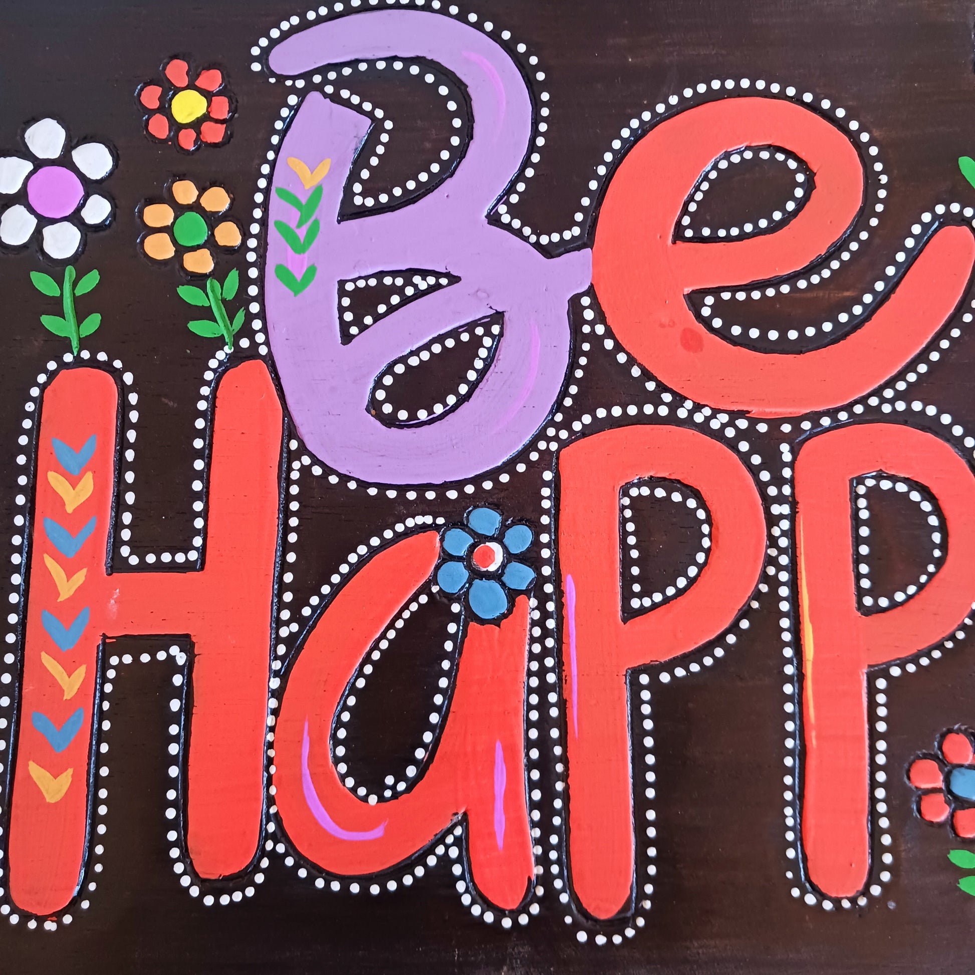 Bring joy and positivity into your home with this handmade “Be Happy” Wall Plaque. Expertly crafted and finished by skilled artisans in Indonesia, this vibrant piece features a bold floral design surrounding the uplifting words “Be Happy.” Each plaque is unique, reflecting the natural textures and craftsmanship of traditional artistry.