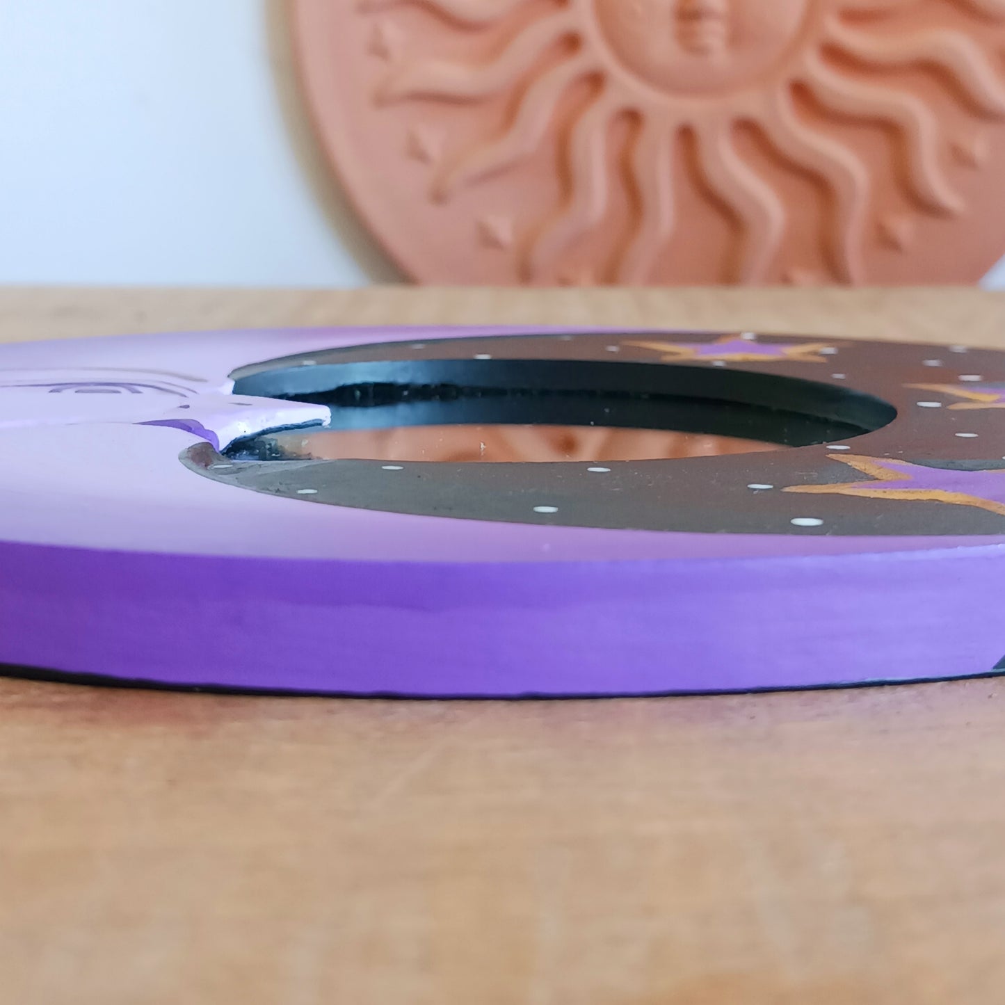 Bring celestial charm and positive energy into your home with this little Handmade Purple Moon Mirror. Carefully crafted by Fair Trade artisans, this unique decorative mirror features a stunning purple crescent moon design that adds a mystical and spiritual touch to any room.