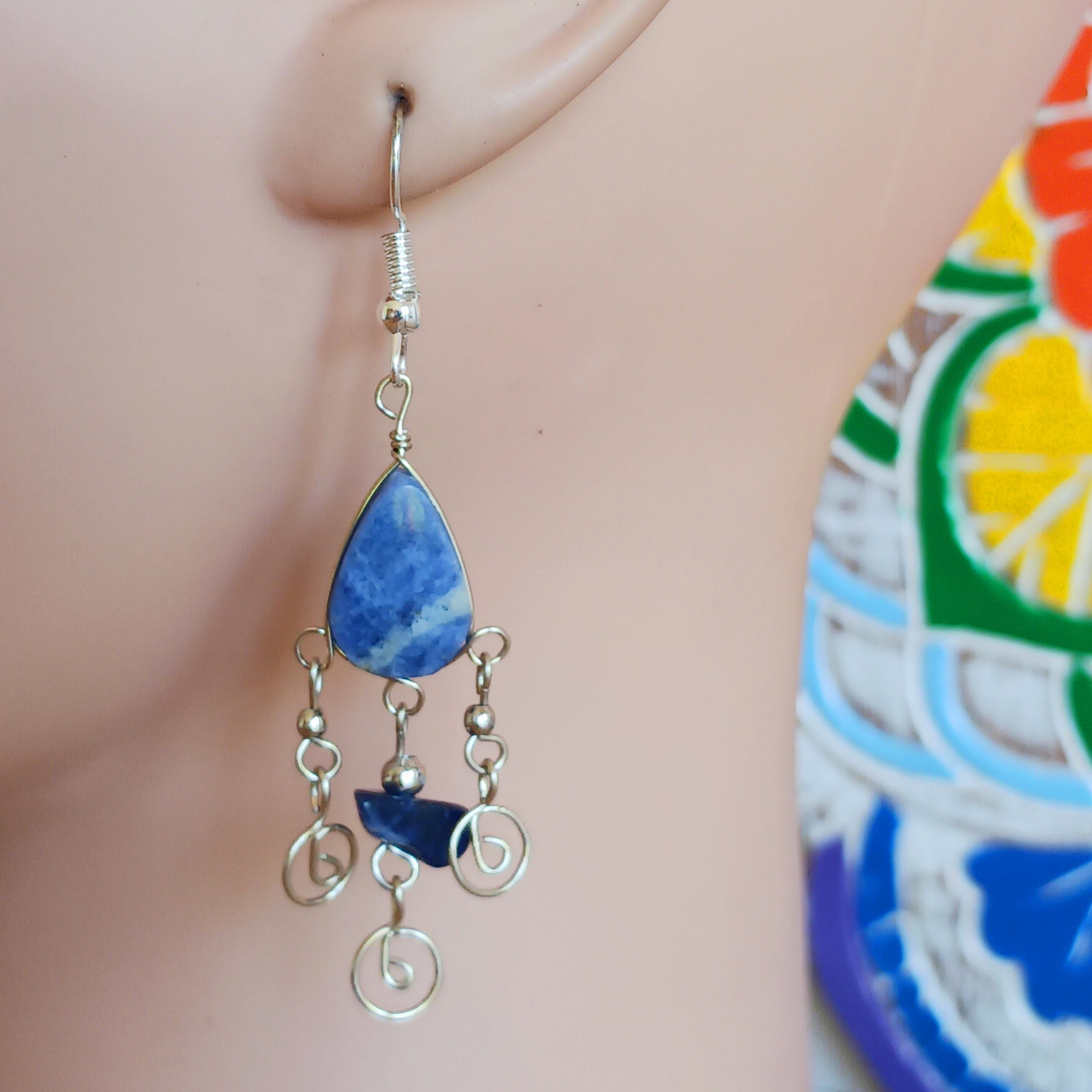 These beautiful spiral earrings feature a lapis lazuli stone and three spirals. They dangle really nicely when worn, and are easy to dress up or down.  The hooks are made from sterling silver so will be something that you can wear season after season.