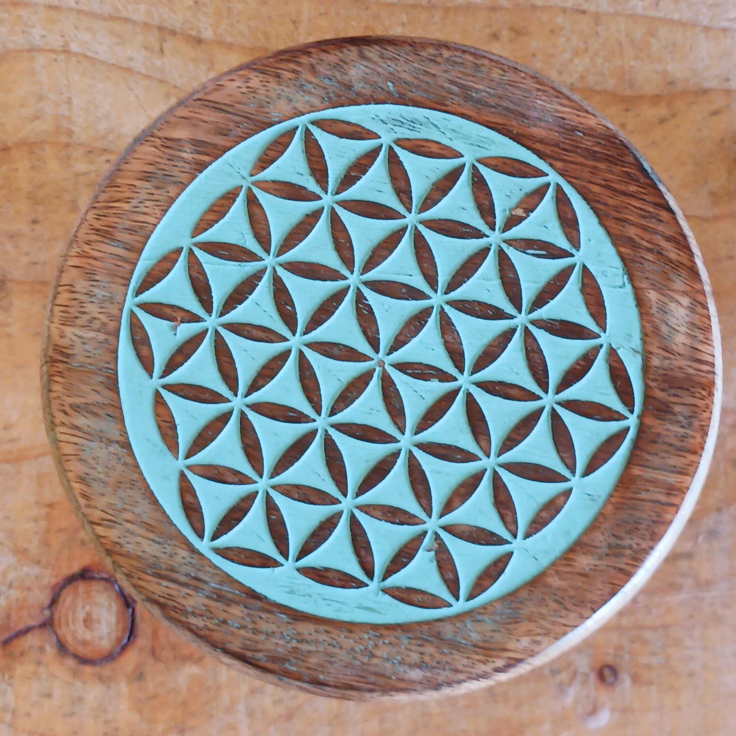 Bring the beauty of sacred geometry into your space with these compact Flower of Life tables. Handcrafted from solid mango wood, each table features a finely engraved Flower of Life symbol on top – an ancient pattern representing the interconnectedness of all life. 