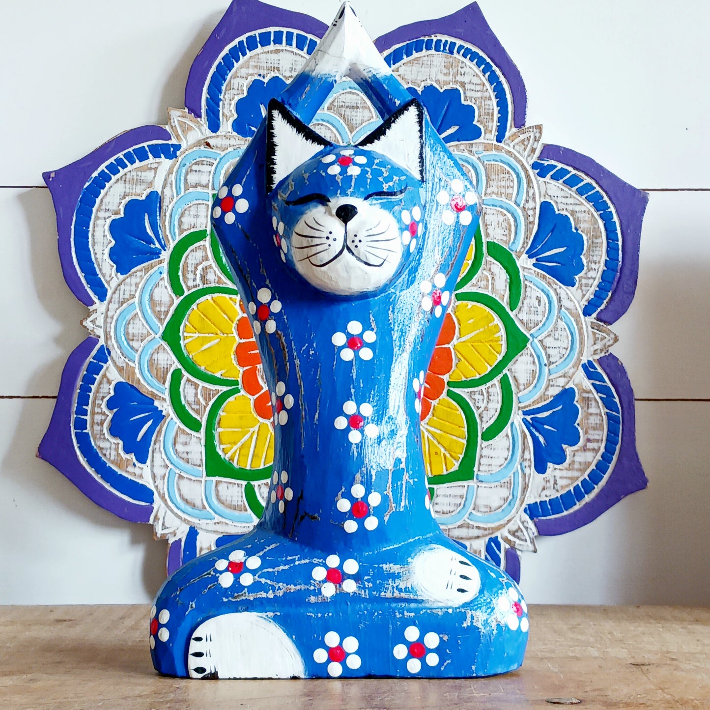 Bring serenity and mindfulness into your home with this beautifully handcrafted Blue Yogi Cat Statue. Designed in a peaceful prayer yoga pose and adorned with delicate floral details, this charming decorative piece inspires relaxation, balance, and positive energy.