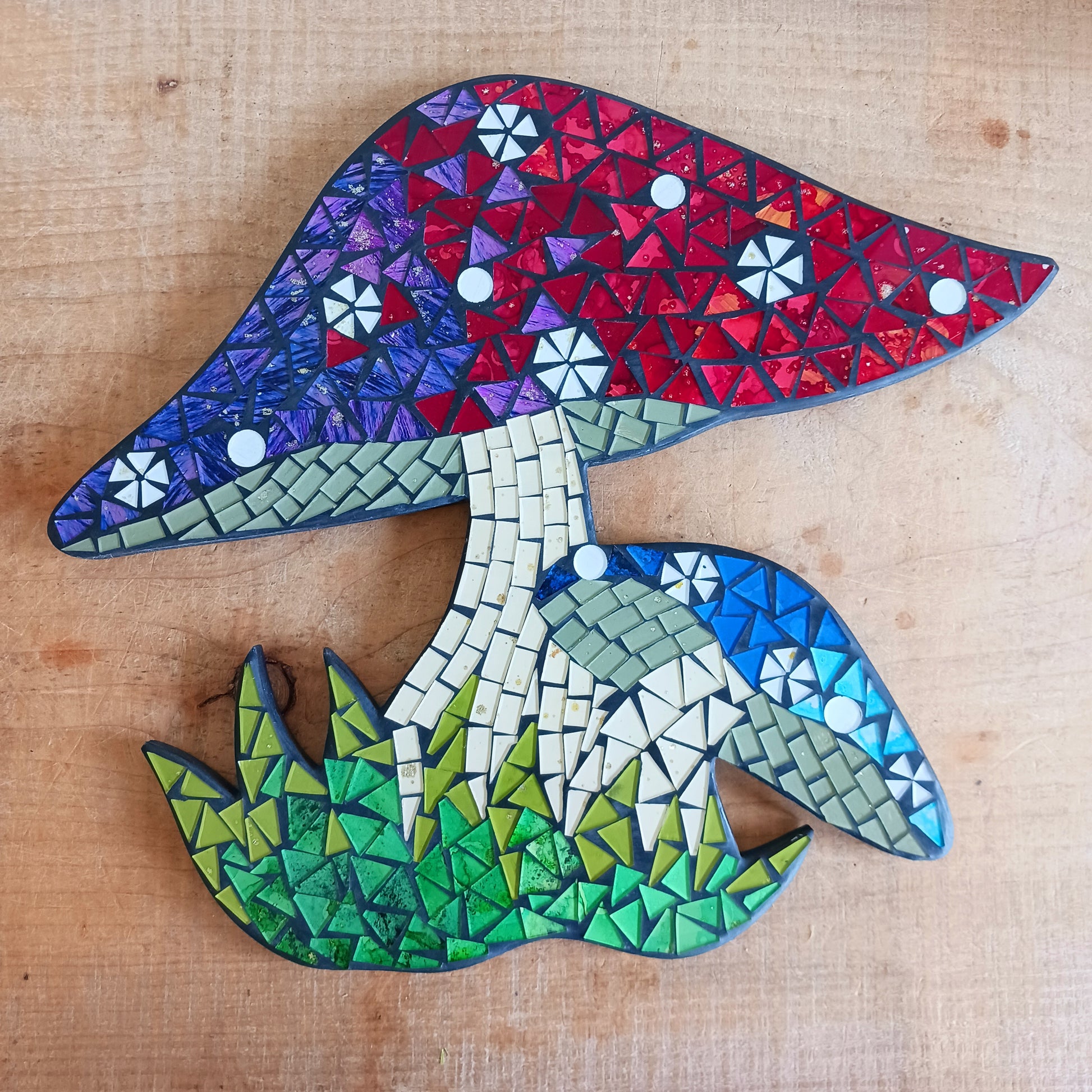 Bring a touch of enchantment to your home with this unique Mosaic Toadstool Plaque, a charming decorative accent designed to add warmth, personality, and whimsical style to any room. Featuring an adorable toadstool mushroom design with a beautiful mosaic-inspired finish, this unique wall plaque creates a magical focal point for your living room, bedroom, hallway, nursery, or creative space.