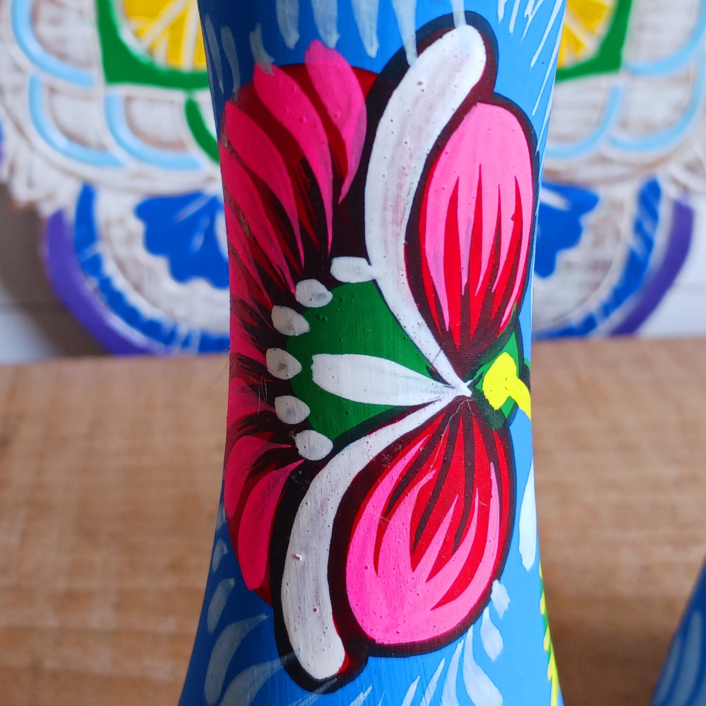 Hand painted in a vibrant blue hue and adorned with the Shapla (waterlily) flower — the national flower of Bangladesh, this fair trade candle holder is a true statement piece. Display it prominently or gift it to someone special as a unique, ethical, and meaningful present. Beautiful on its own or paired with others, it adds warmth, tradition, and cheerful design to any space.