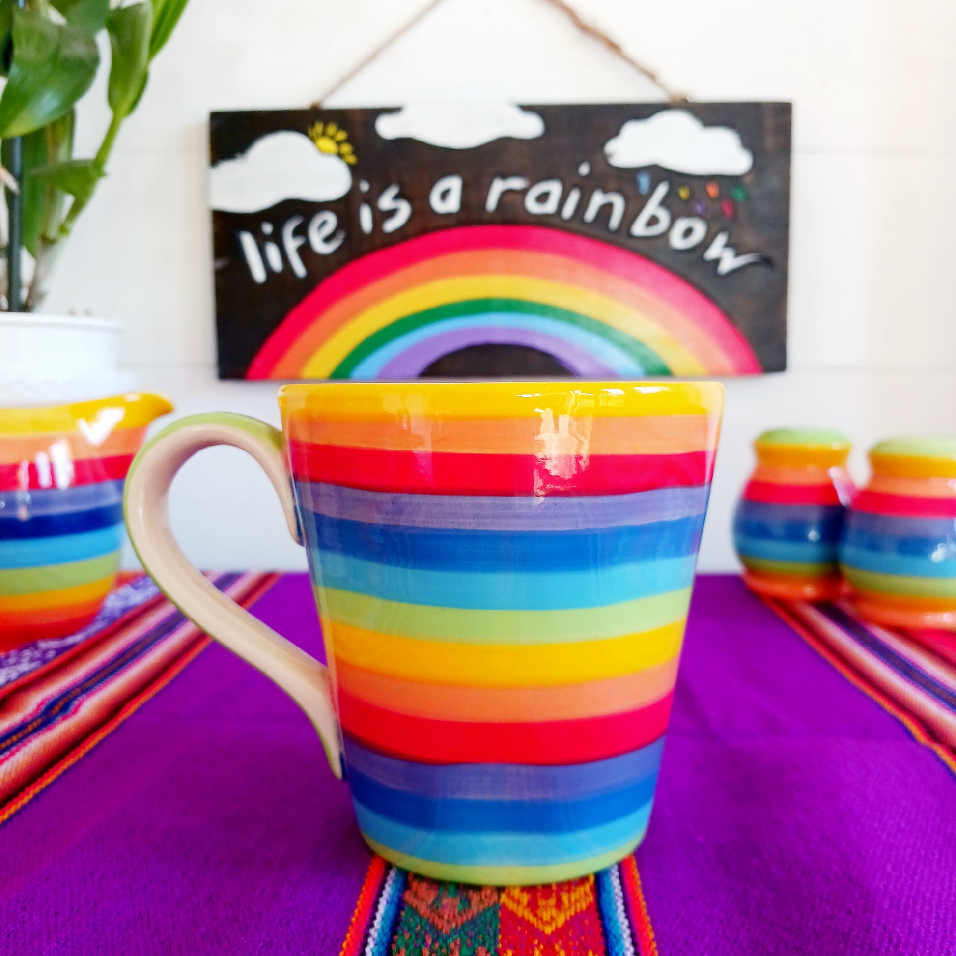 The rainbow stripe is hand painted before it is fired and finishes it beautifully. Narrower in diameter at the bottom and widening towards the rim, these Thai ceramics are traditionally made, hand painted with a pale green interior and finished to a shine glaze highlighting the vibrant multi colours perfectly.