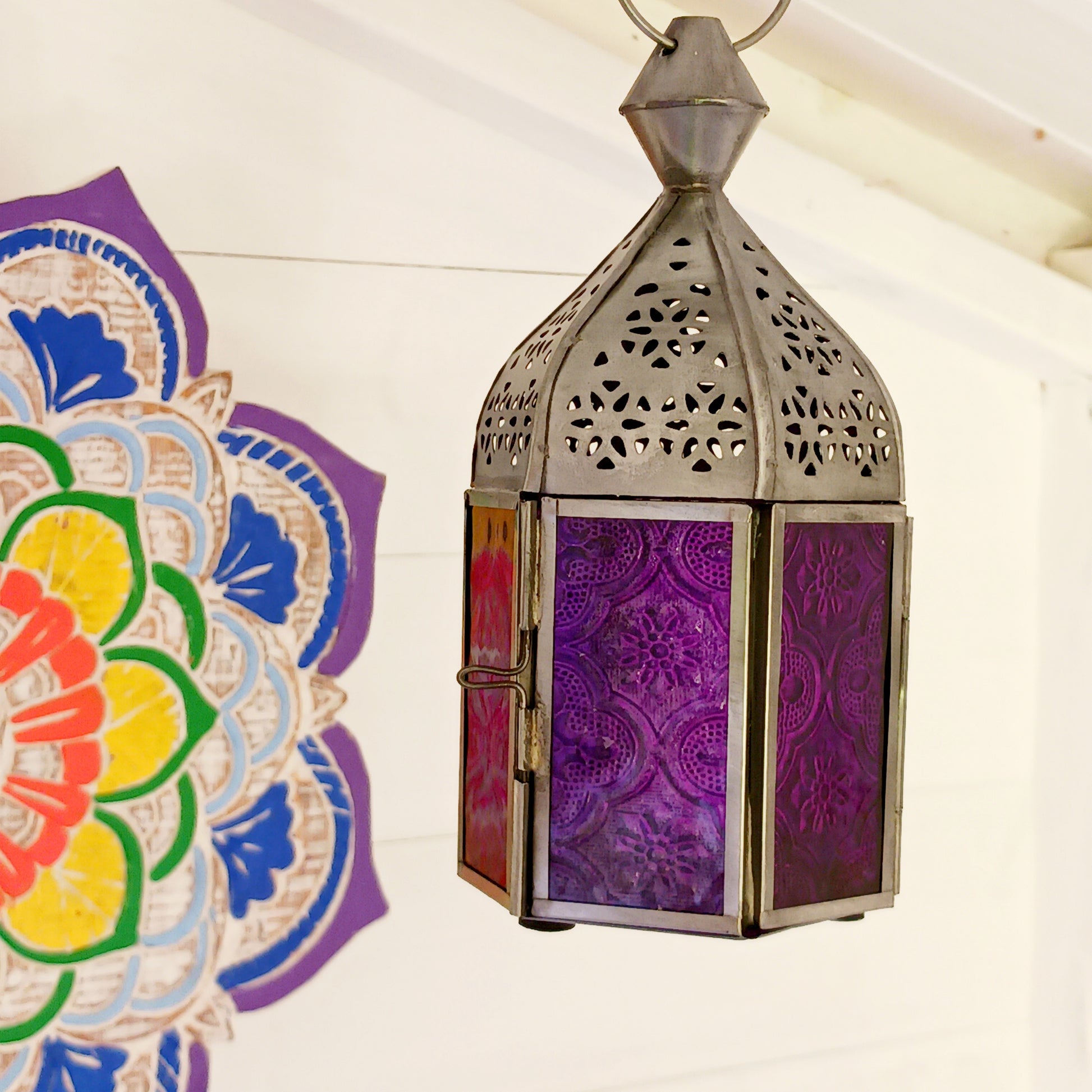 These small glass lanterns come in wonderful colours, featuring an intricate embossed pattern. They have a small hinged door that closes with a sliding catch. The small handle on the top is great for hanging the lanterns around your home. Perfect for adding a touch of warmth to your space.