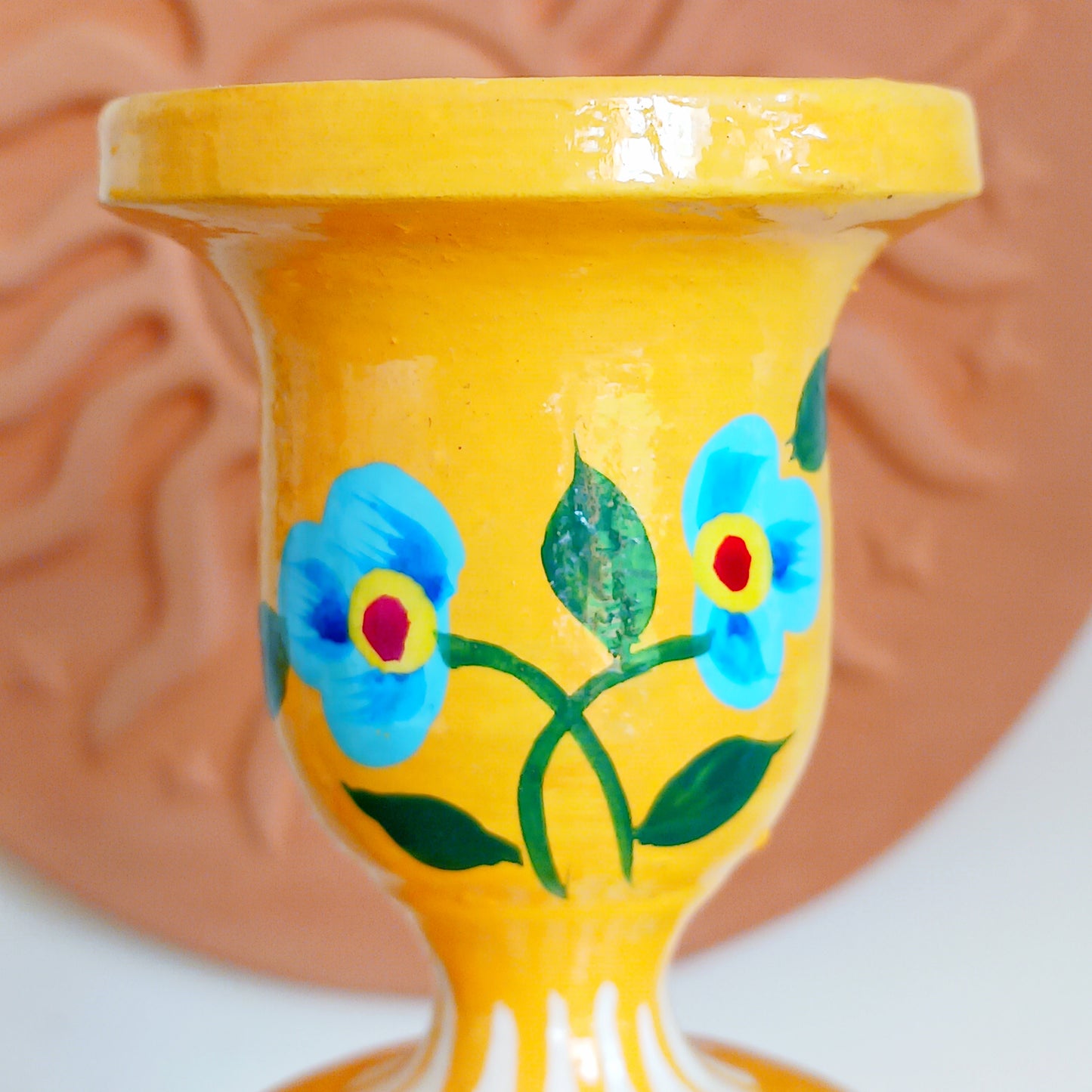 Add warmth, colour, and artisan beauty to your home with these hand painted yellow wooden candlesticks, beautifully crafted from sustainably sourced wood. Each piece is carefully painted by skilled artisans and decorated with elegant chrysanthemum flowers, a symbol of positive life forces including love, appreciation, longevity, happiness, and optimism.