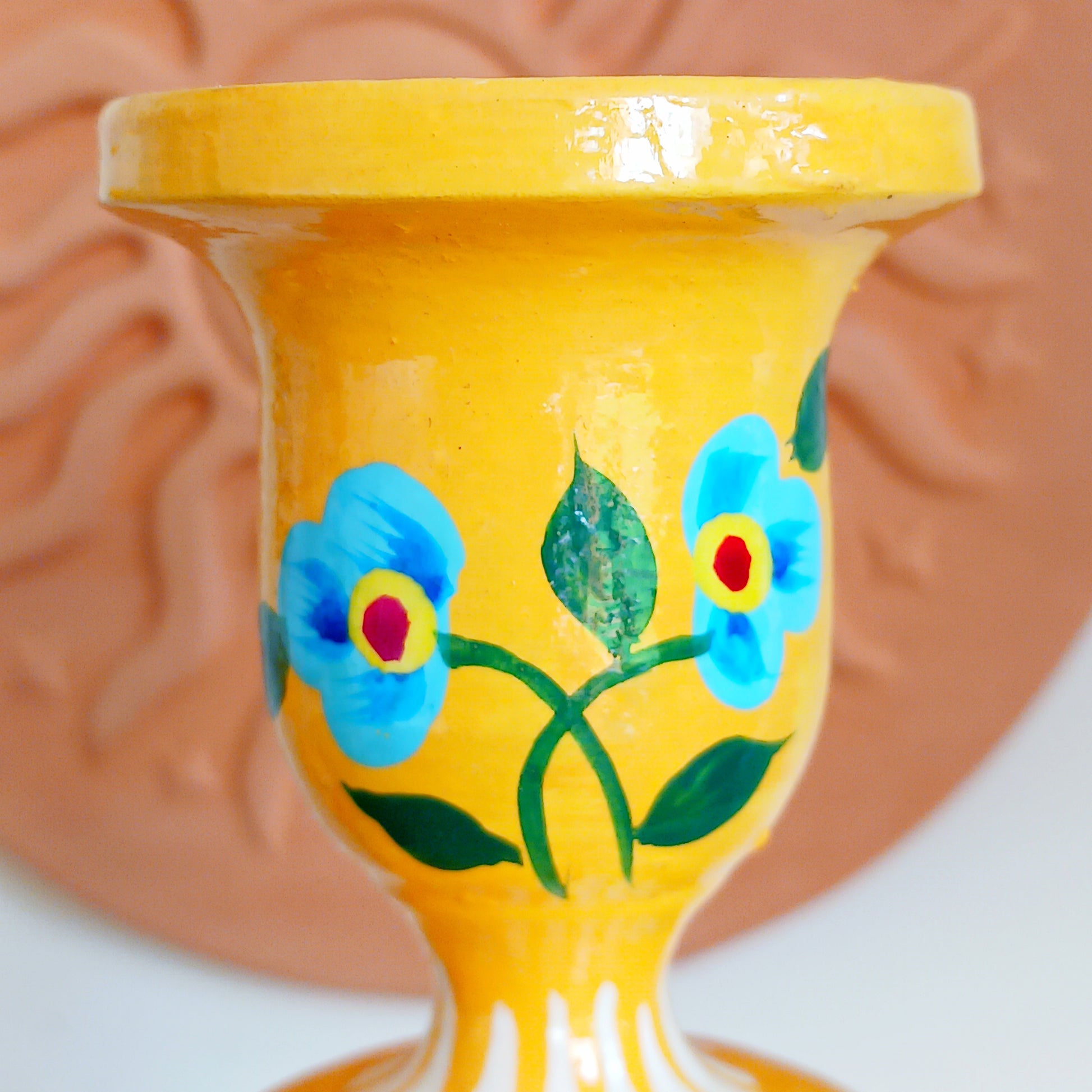 Add warmth, colour, and artisan beauty to your home with these hand painted yellow wooden candlesticks, beautifully crafted from sustainably sourced wood. Each piece is carefully painted by skilled artisans and decorated with elegant chrysanthemum flowers, a symbol of positive life forces including love, appreciation, longevity, happiness, and optimism.