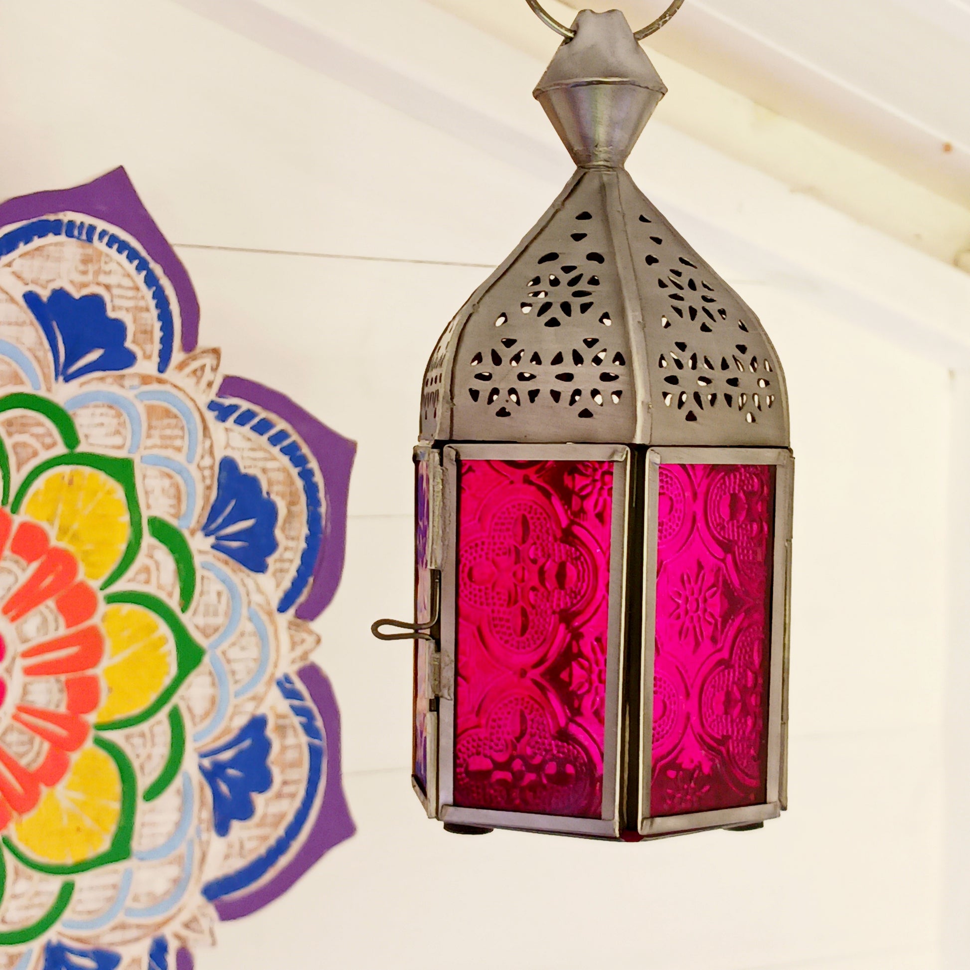 These small glass lanterns come in wonderful colours, featuring an intricate embossed pattern. They have a small hinged door that closes with a sliding catch. The small handle on the top is great for hanging the lanterns around your home. Perfect for adding a touch of warmth to your space.