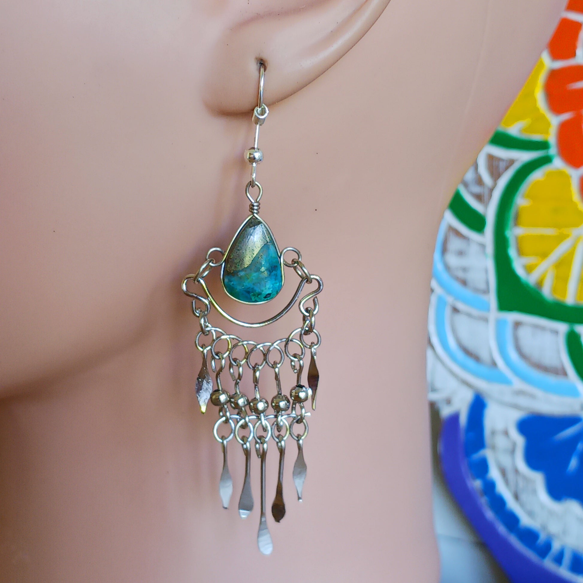 These beautiful earrings incorporate a dark turquoise stone with Silver plated hooks. These earrings have been hand made and are presented in a traditionally made pouch gift wrapped and ready to give ☸