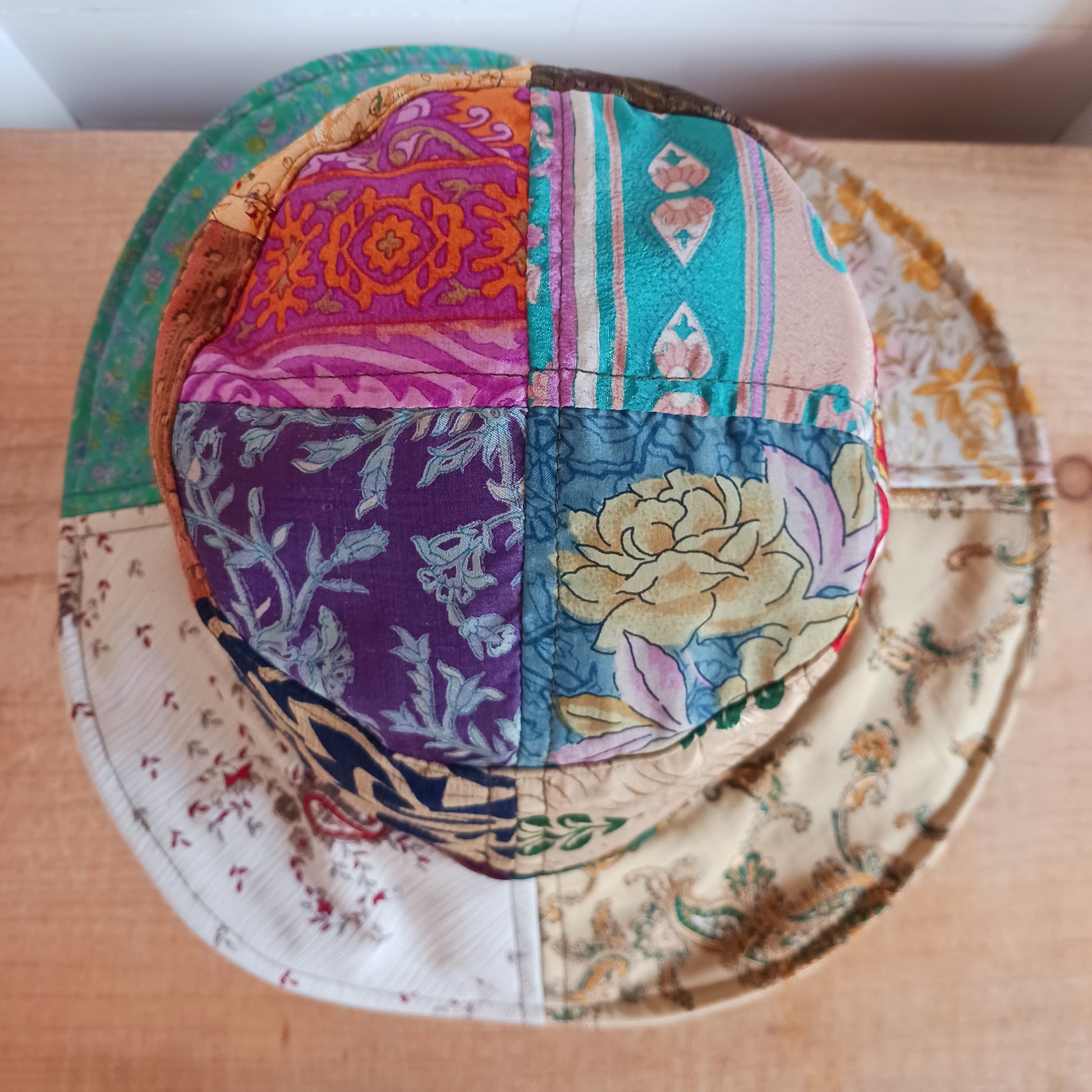 A swell little number for festivals and summer times, you'll look the coolest in this recycled sari patchwork sun hat. Black polyester lined, with a slightly flexible brim for adjusting the shape.