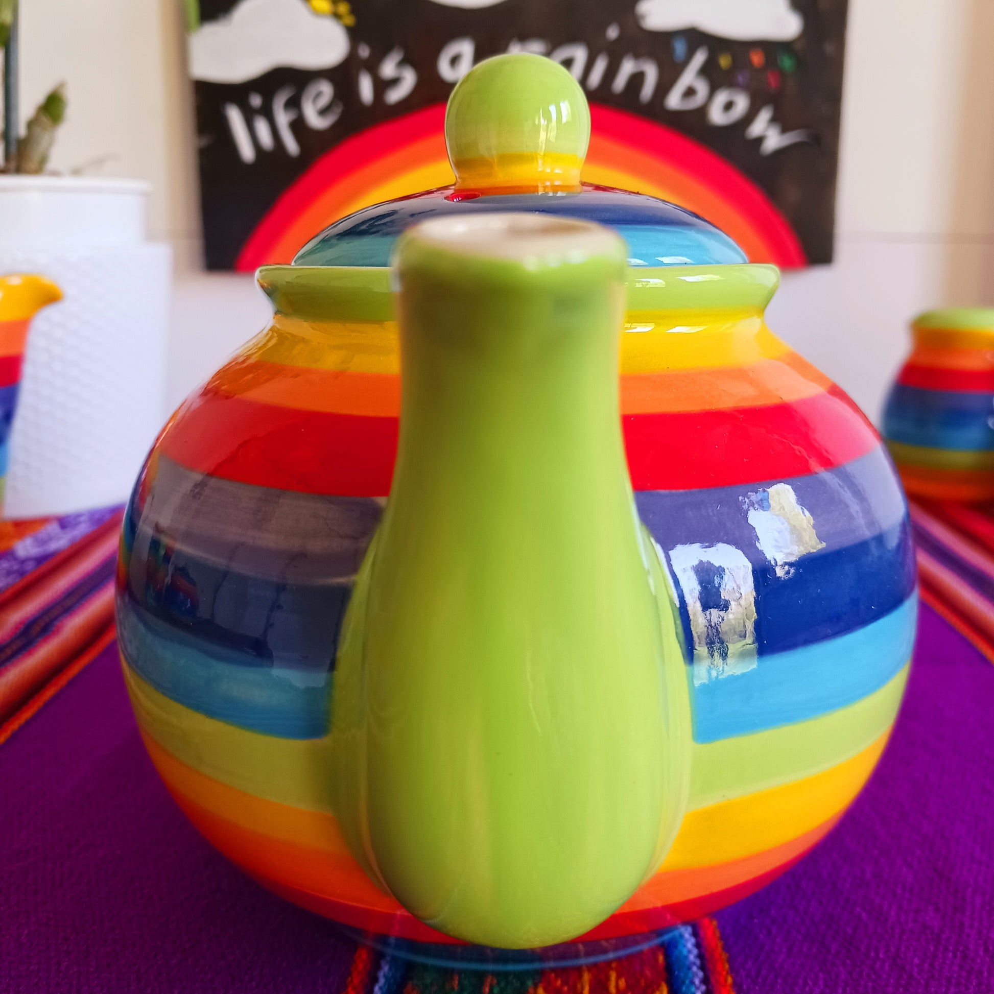 Experience the perfect fusion of artistry and functionality with this exquisite 2-cup ceramic teapot from Thailand. Handcrafted by skilled artisans, this vibrant teapot features a stunning rainbow stripe, adding a pop of colour and charm to your tea rituals.