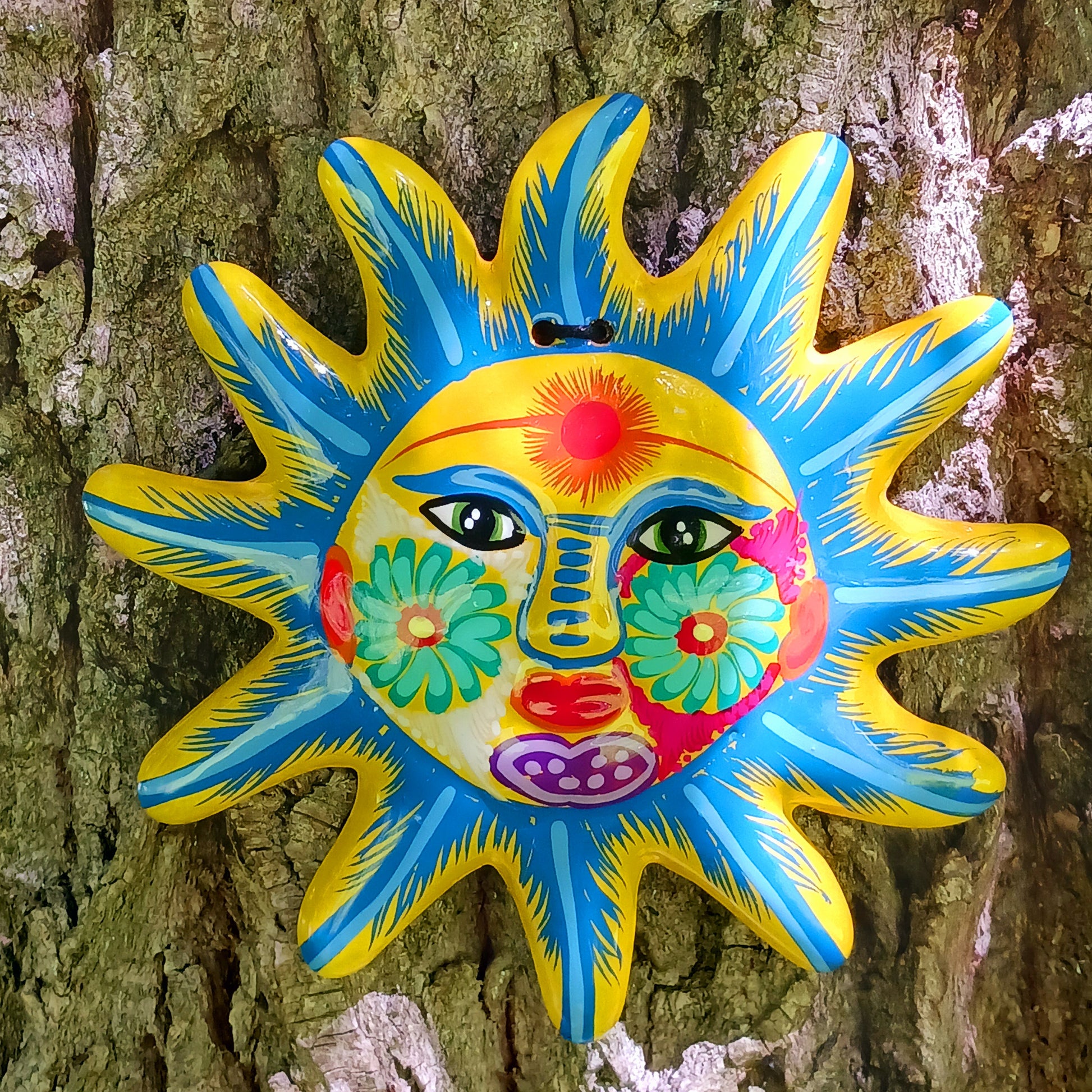 Bring a burst of colour and joy into your space with this sunny, vibrant wall plaque! Expertly hand-painted in the bold, traditional style of Xalitla, Guerrero, Mexico, this decorative piece radiates cultural charm. The vivid colors and striking glaze add depth and personality, making it a standout feature in any room. With two convenient holes for easy hanging, it’s ready to brighten your home with authentic folk art flair.