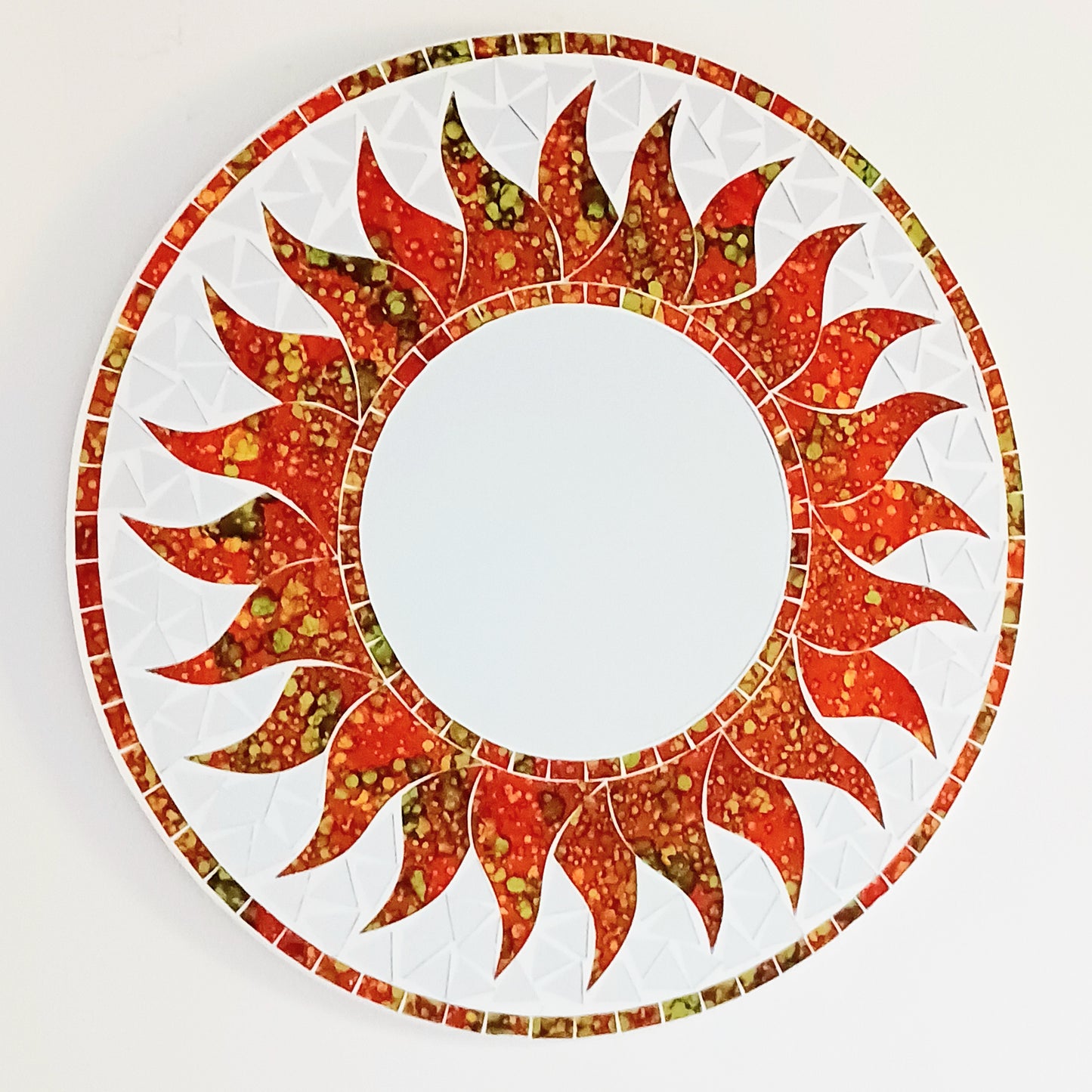 dd warmth, energy, and artistic charm to your home with this beautiful Vibrant Orange Mosaic Sun Mirror. Designed with dazzling orange mosaic tiles arranged in a radiant sunburst pattern, this captivating wall accent instantly brightens any room. 