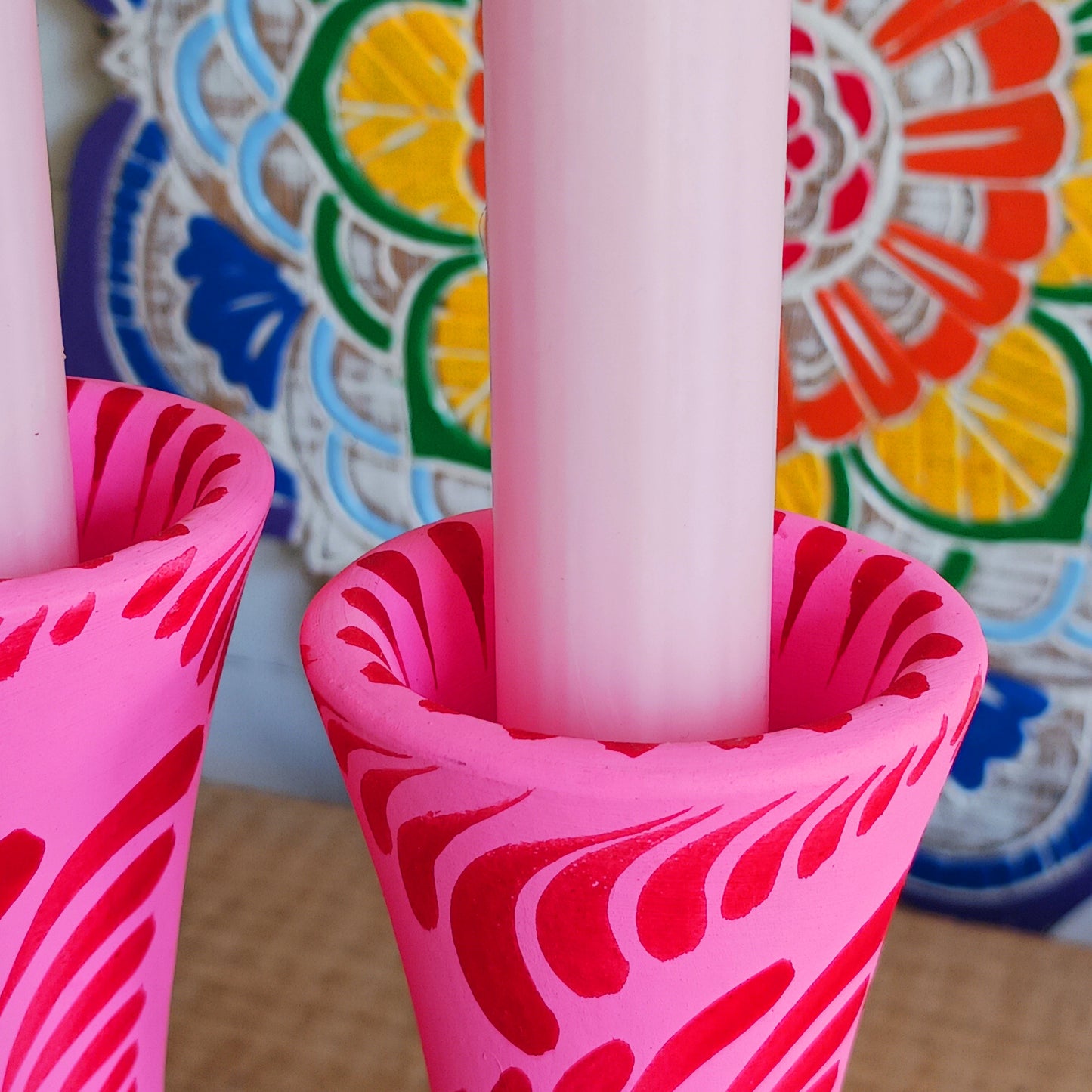 Hand painted in a vibrant&nbsp;pink&nbsp;hue and adorned with the Shapla (waterlily) flower — the national flower of Bangladesh, this fair trade candle holder is a true statement piece. Display it prominently or gift it to someone special as a unique, ethical, and meaningful present. Beautiful on its own or paired with others, it adds warmth, tradition, and cheerful design to any space.