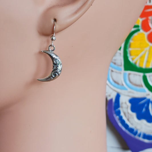 These exquisite sterling silver earrings feature a delicate Celtic spiral design beautifully interwoven in the crescent moon shape, symbolizing the waxing and waning phases. Crafted with fine attention to detail, each earring mirrors the other, representing balance in nature and the eternal cycles of life, growth, and renewal.